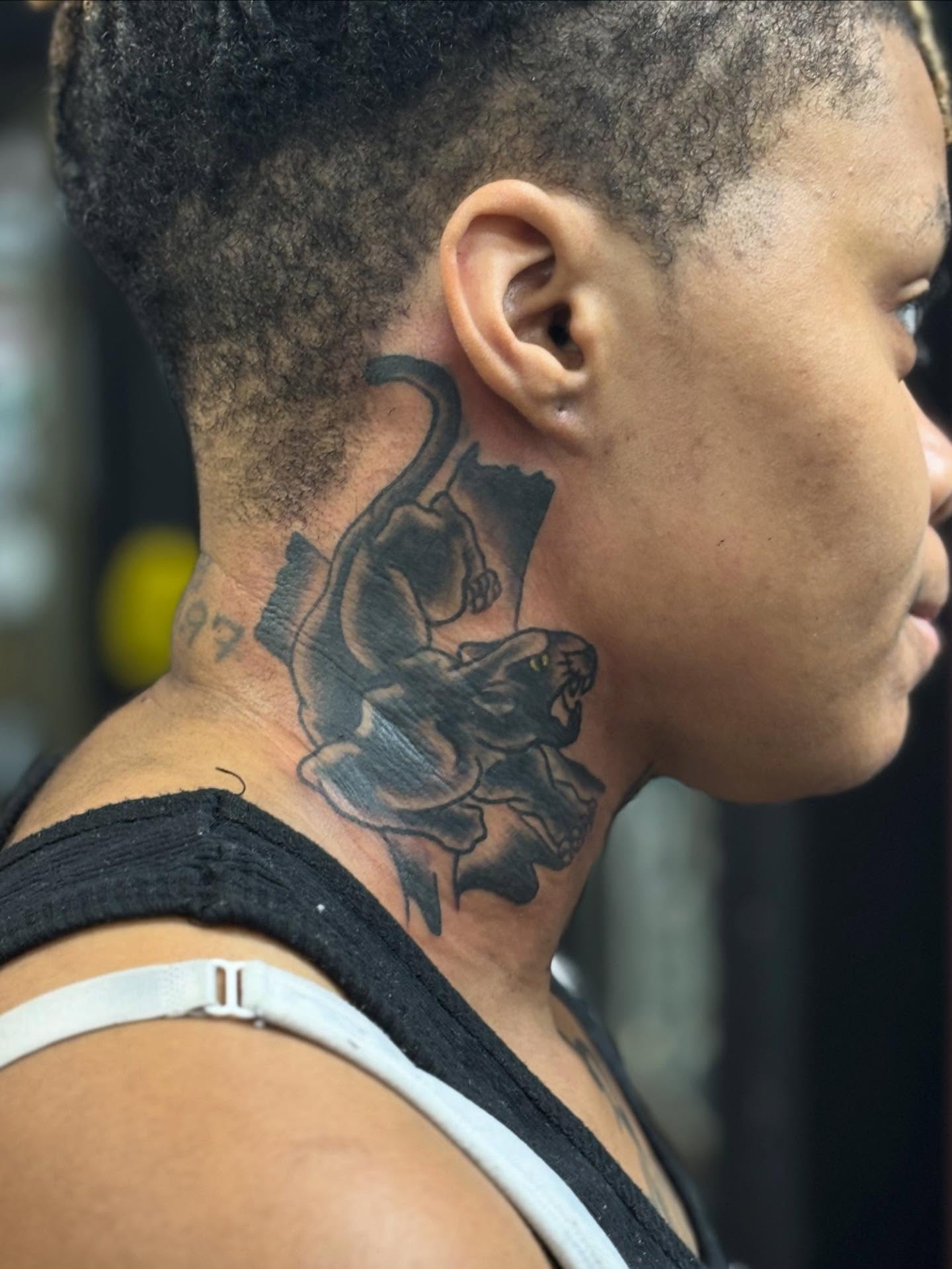 Panther and rose black and grey tattoo on the neck by Columbus tattoo artist