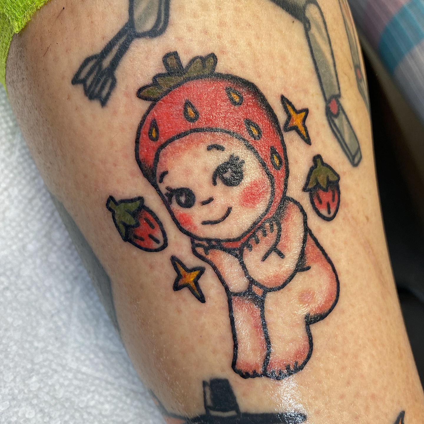 Strawberry baby American traditional tattoo on the forearm by Corinne Carter