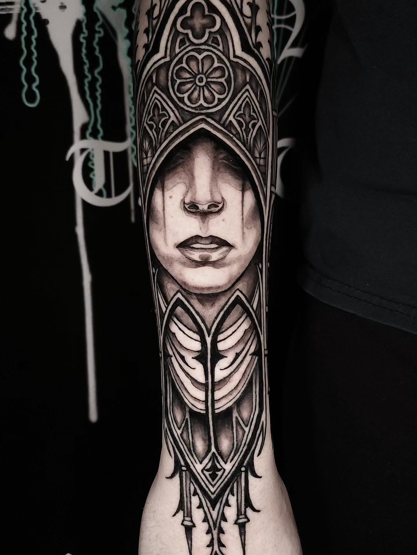 Hooded figure geometric tattoo on the forearm by Mario Romero
