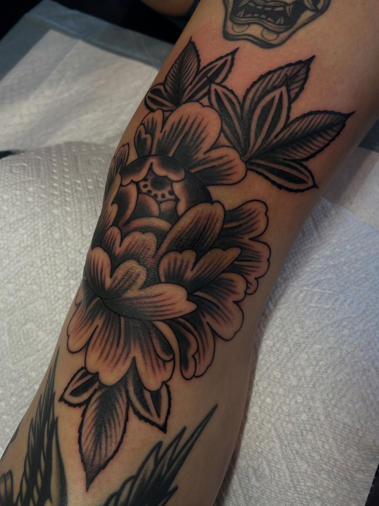 Flower black and grey tattoo on the forearm by Lilly Binns