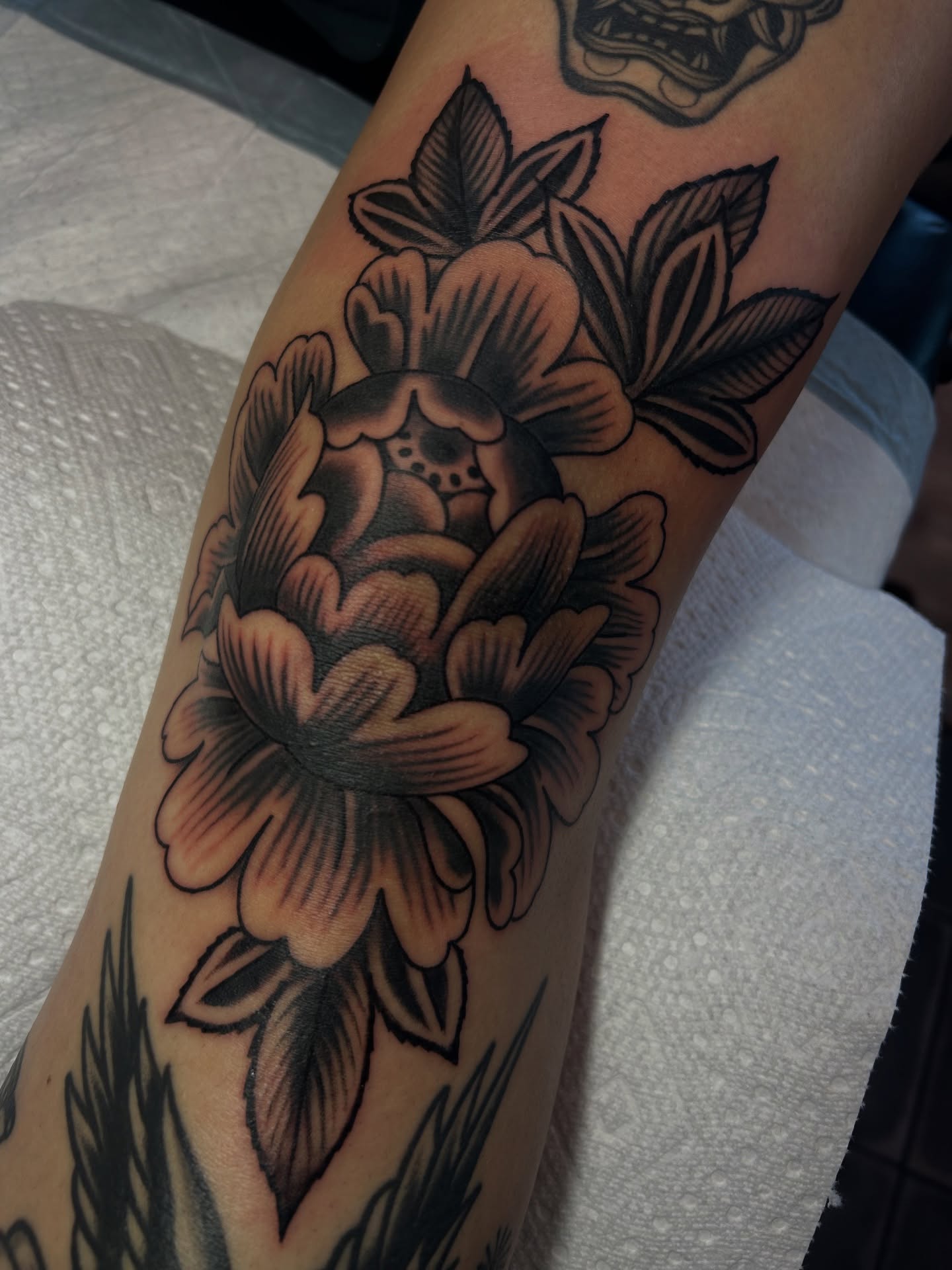 Peony American traditional tattoo on the forearm by Lilly Binns