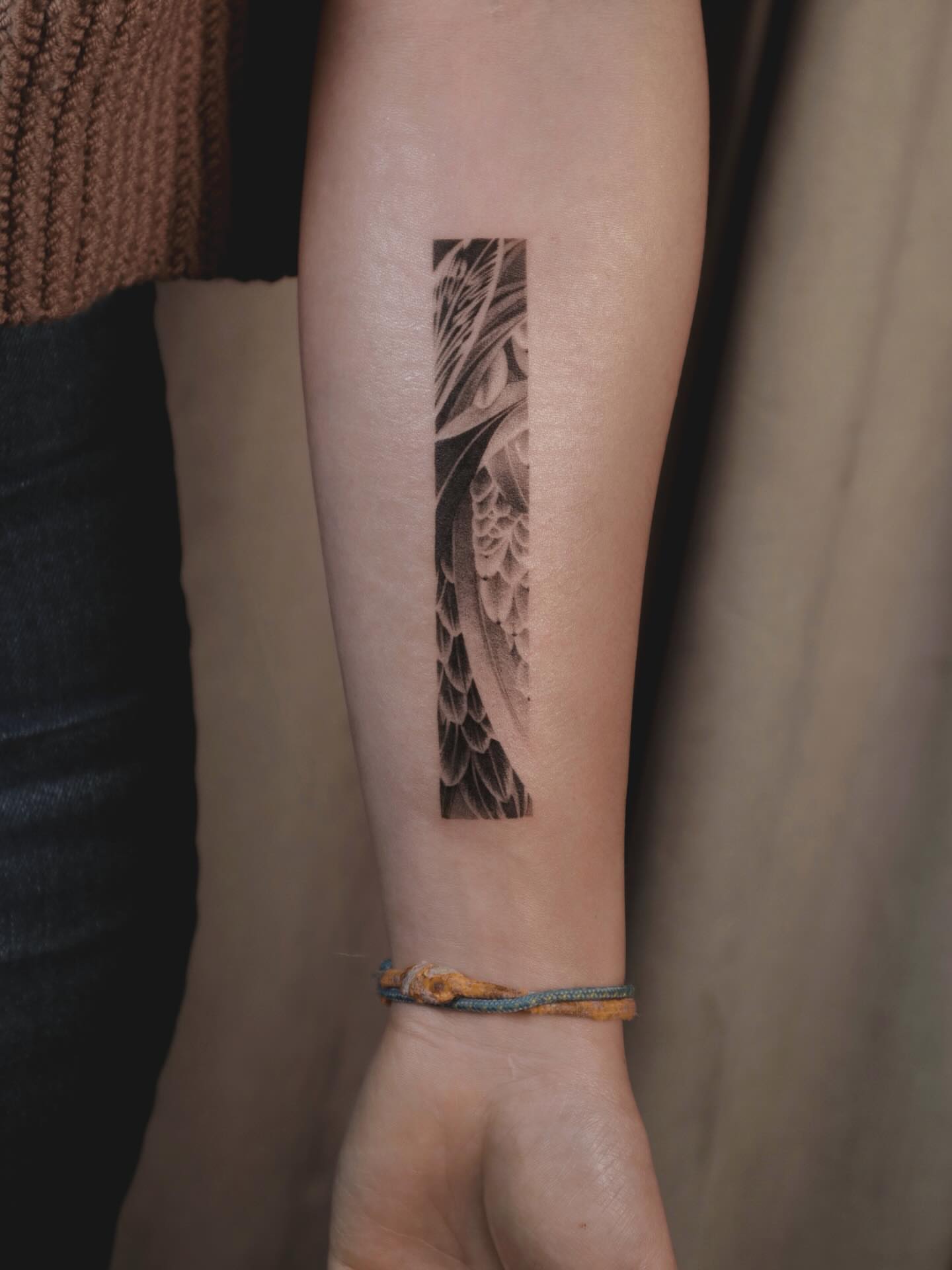Feather black and grey tattoo on the forearm by River, New York, New York