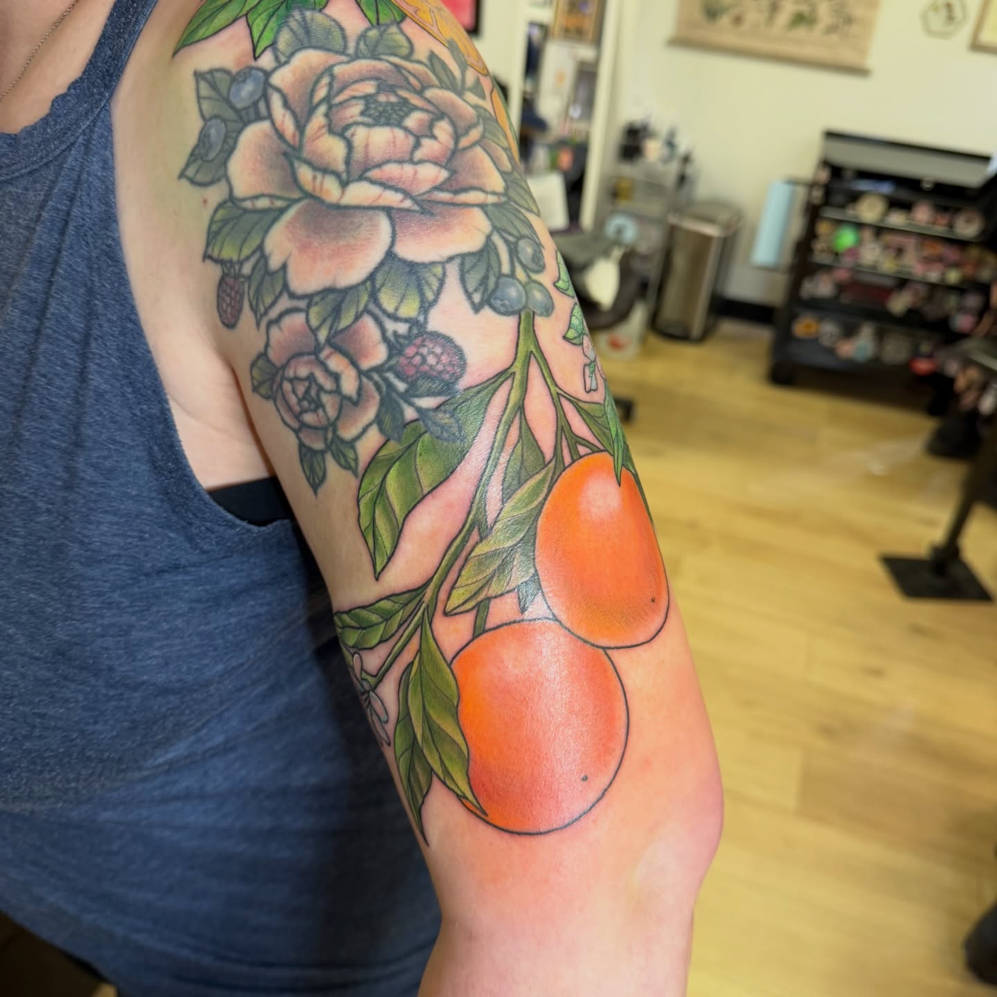 Peony and oranges realism tattoo on the forearm by Dani Fried Tattoos