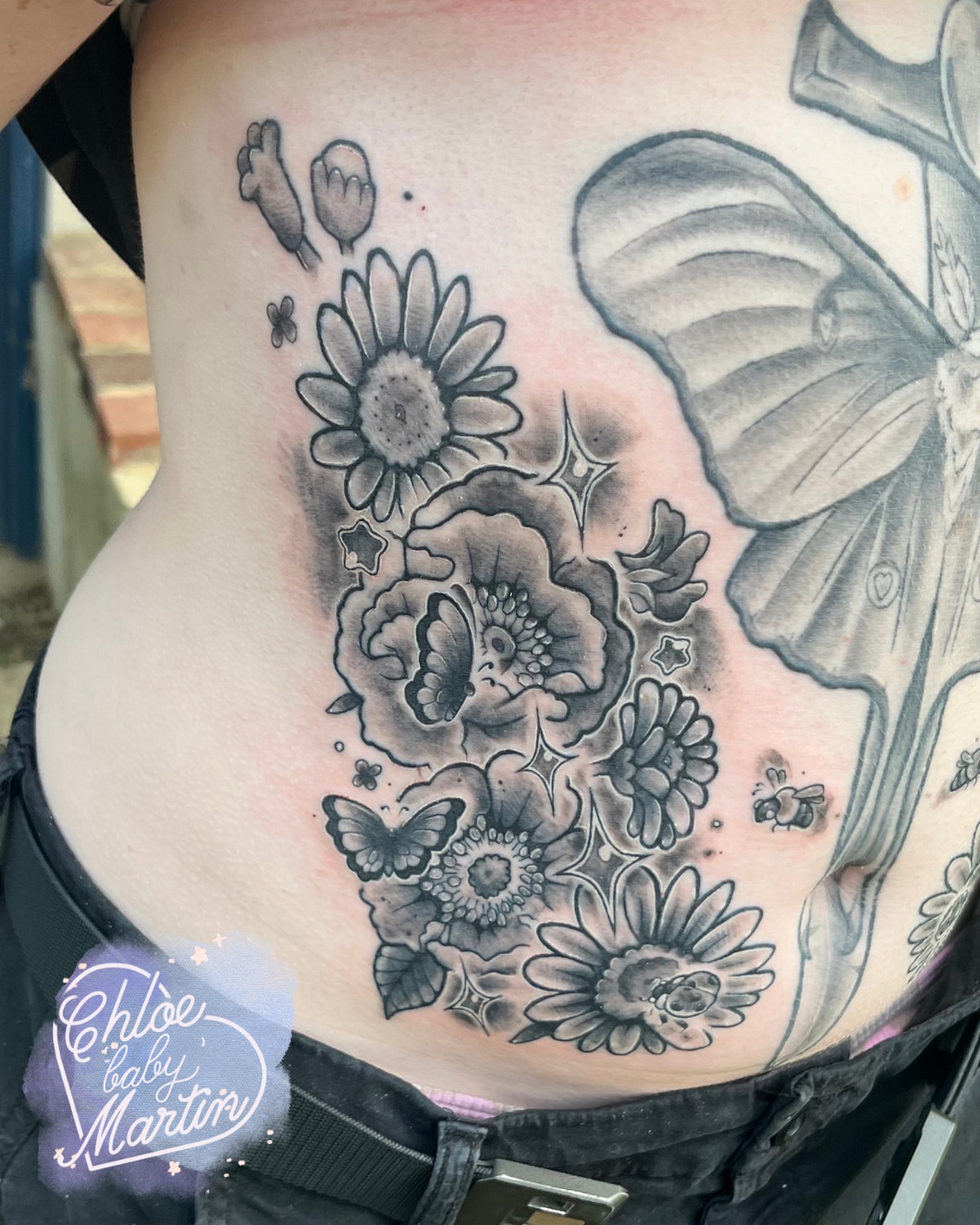 Floral bouquet black and grey tattoo on the ribs by Chloe ‘baby’ Martin