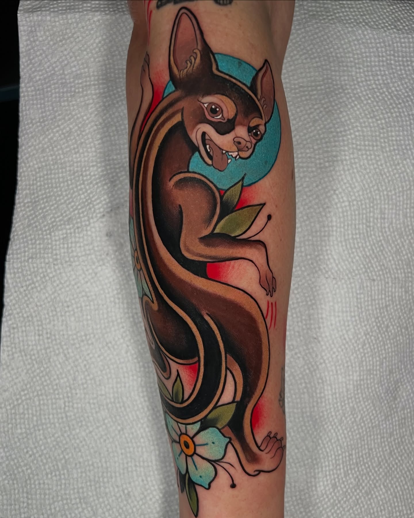Bat and flower American traditional tattoo on the forearm by Skyler Miller