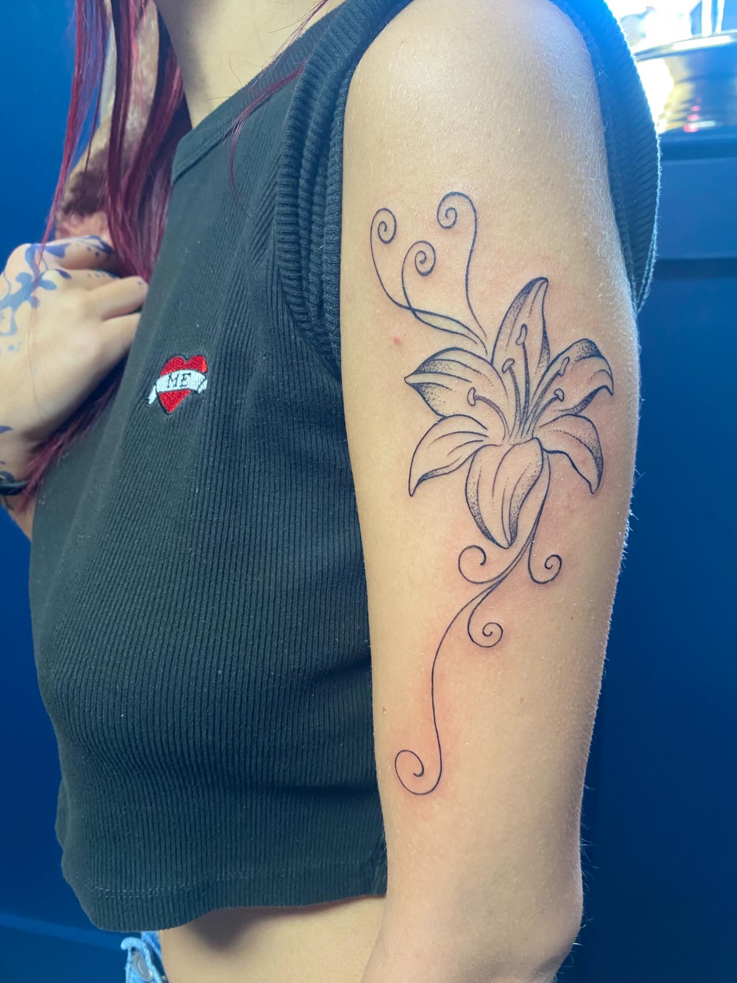 Lily black and grey tattoo on the forearm by Jesikah Rapp