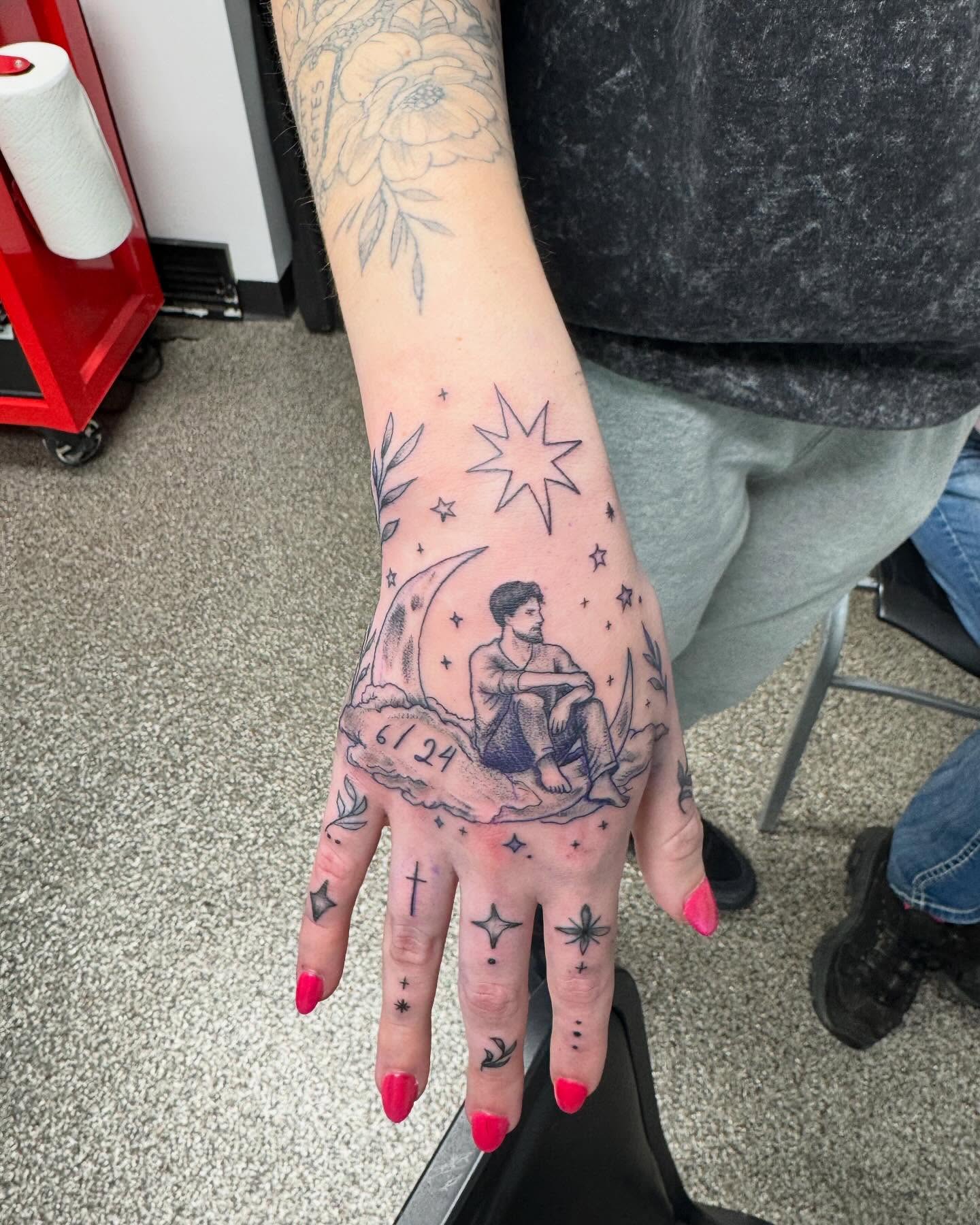 Man sitting on cloud black and grey tattoo on the hand by Brazun Locker Poloschan