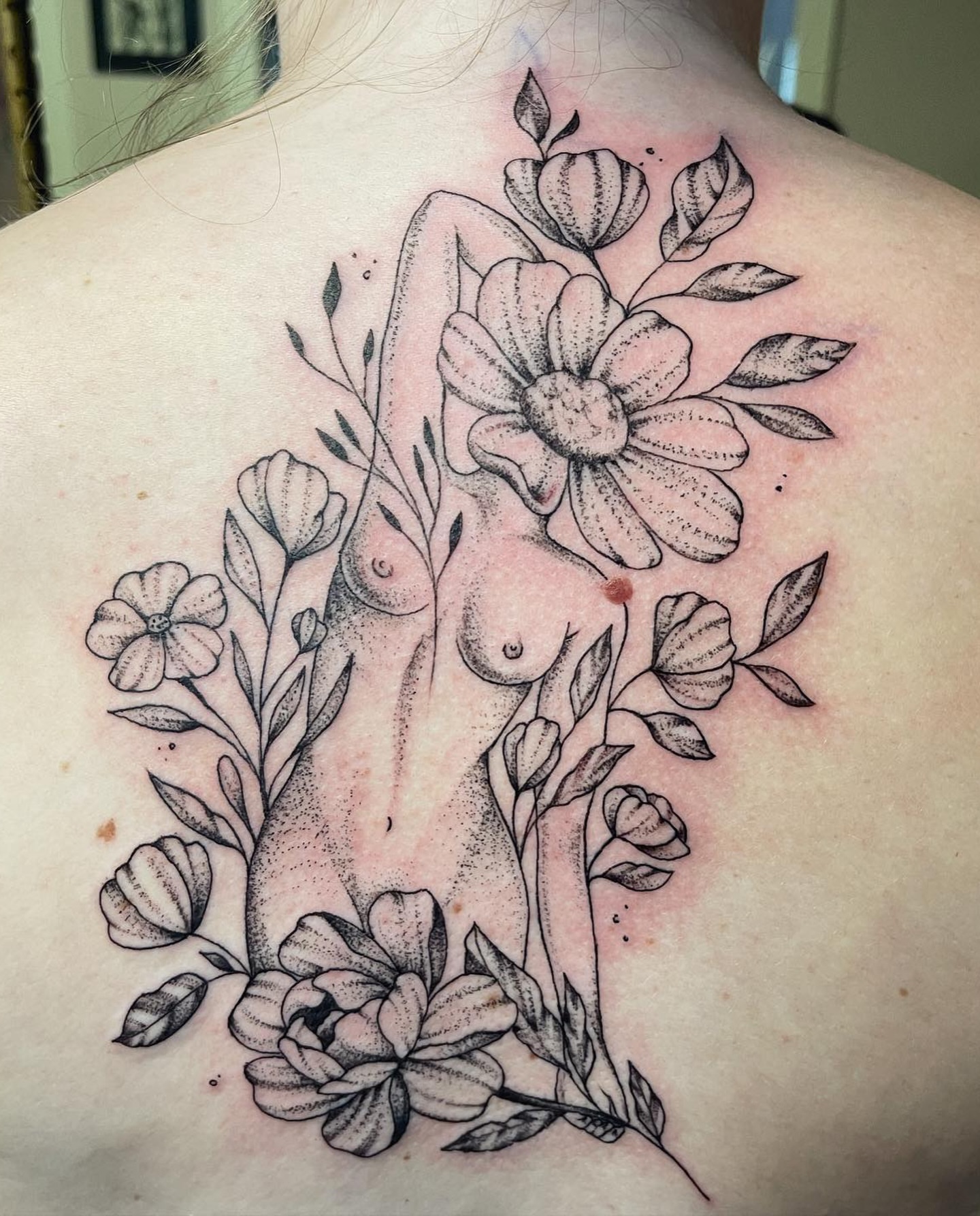 Floral bouquet dotwork tattoo on the back by Brandie