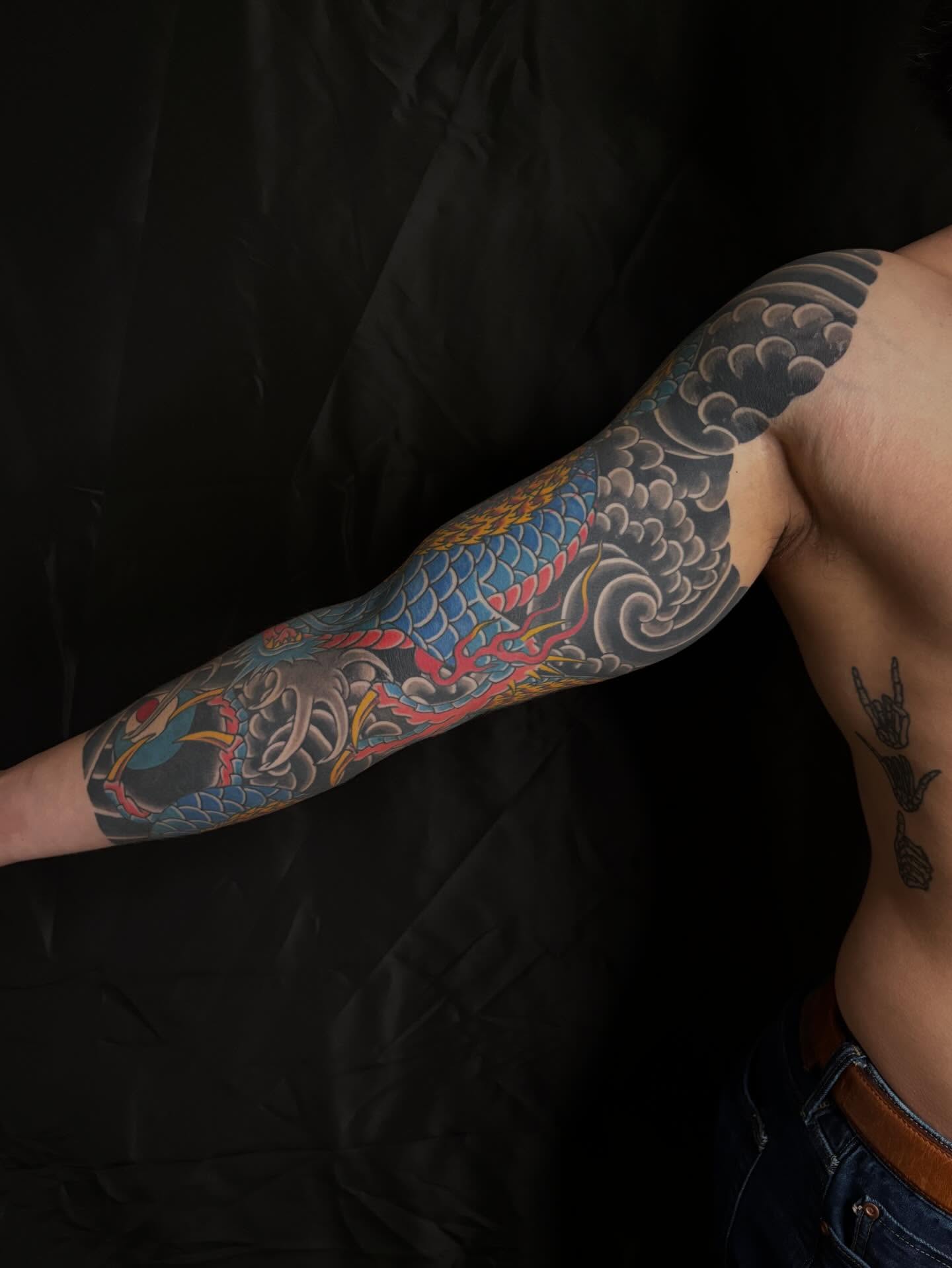 Dragon and waves japanese irezumi tattoo on the upper arm by Zach Hendrickson
