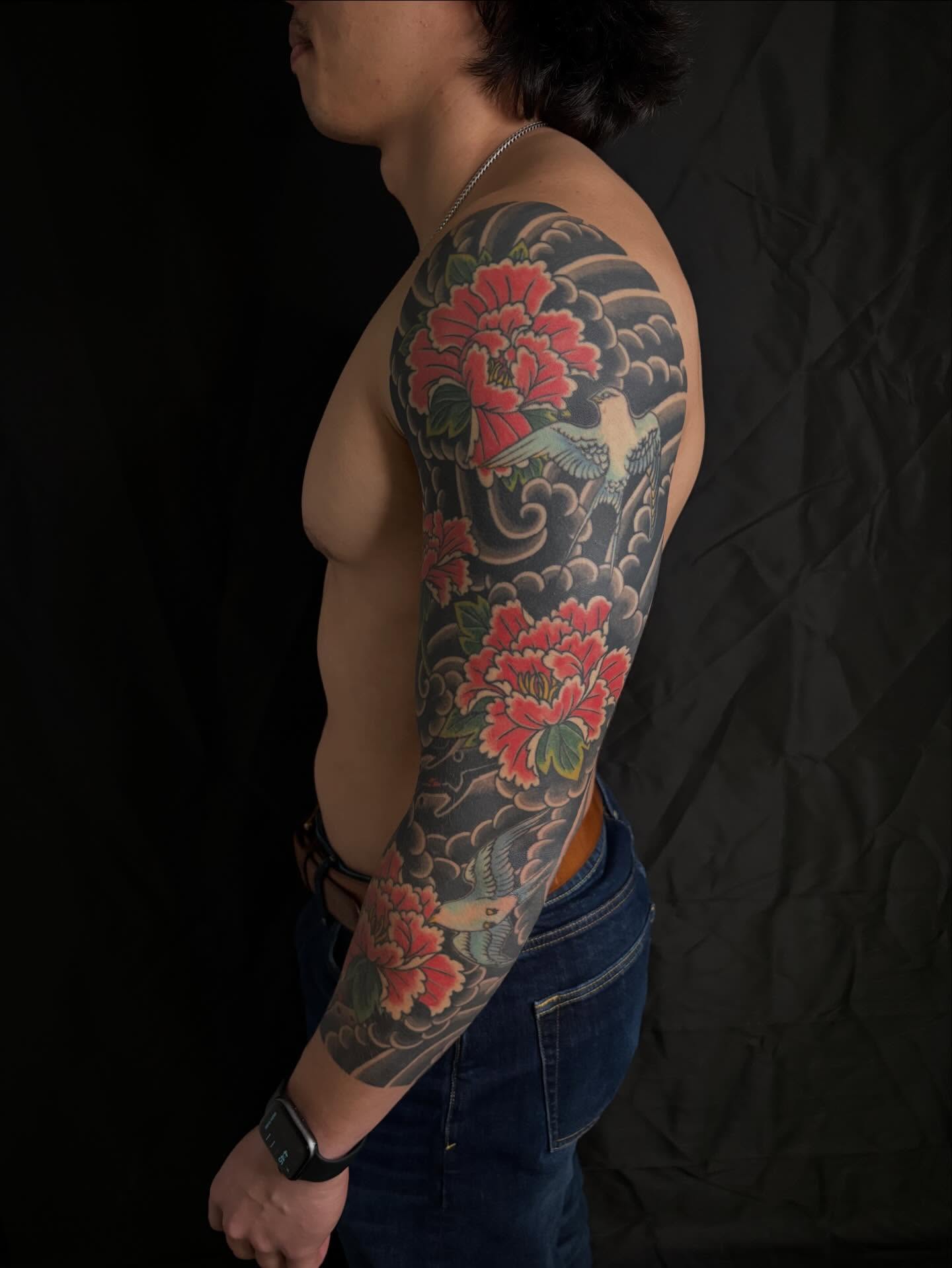 Peony and bird japanese irezumi tattoo on the upper arm by Zach Hendrickson