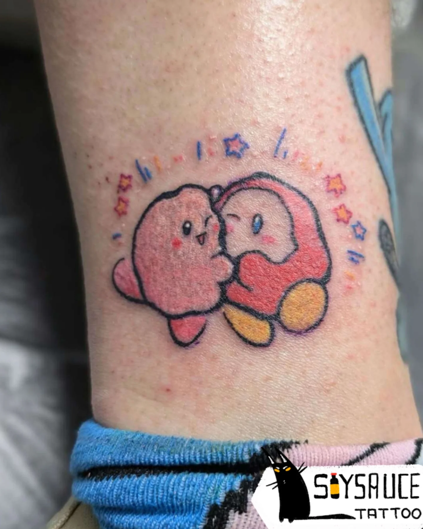 Kissing characters dotwork tattoo on the forearm by Zoe Aucoin