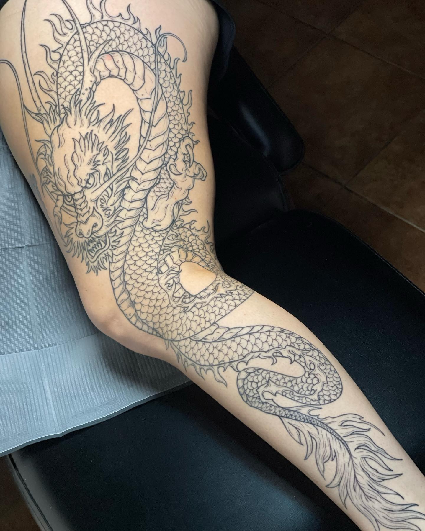 Dragon black and grey tattoo on the forearm by Brandie