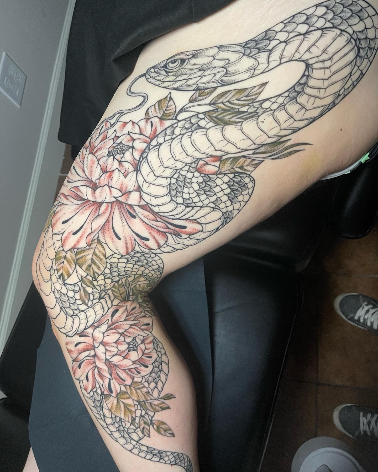 Snake and peony American traditional tattoo on the thigh by Brandie