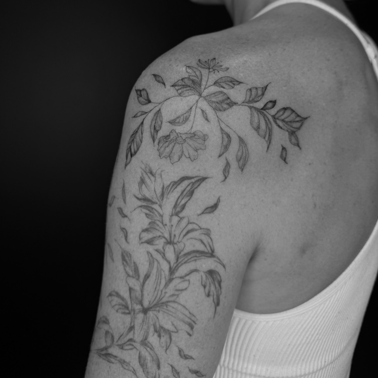 Floral design black and grey tattoo on the shoulder by Ryleigh Benjamin