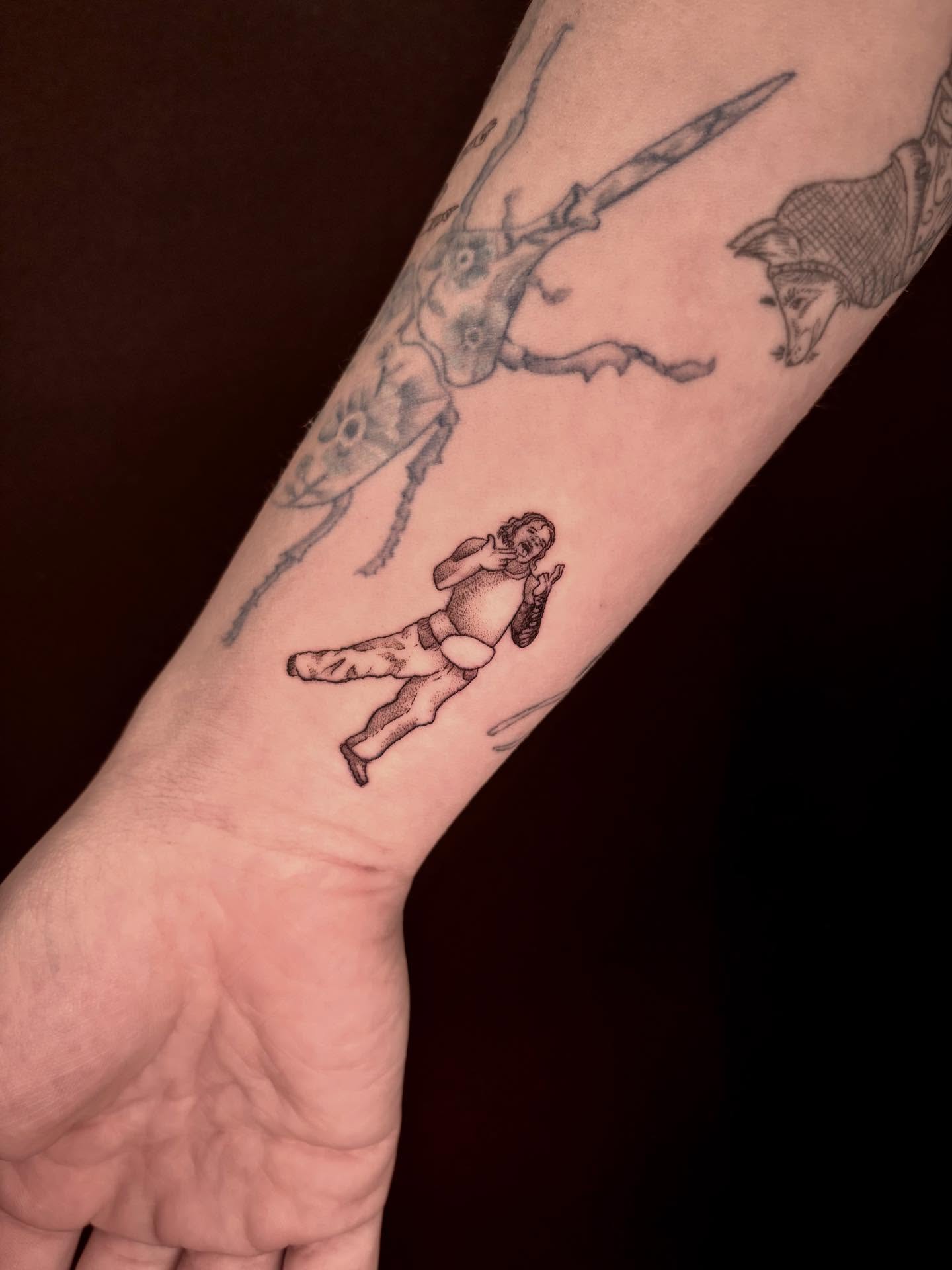 Man running away from giant insect black and grey tattoo on the forearm by Sage Ray ♡