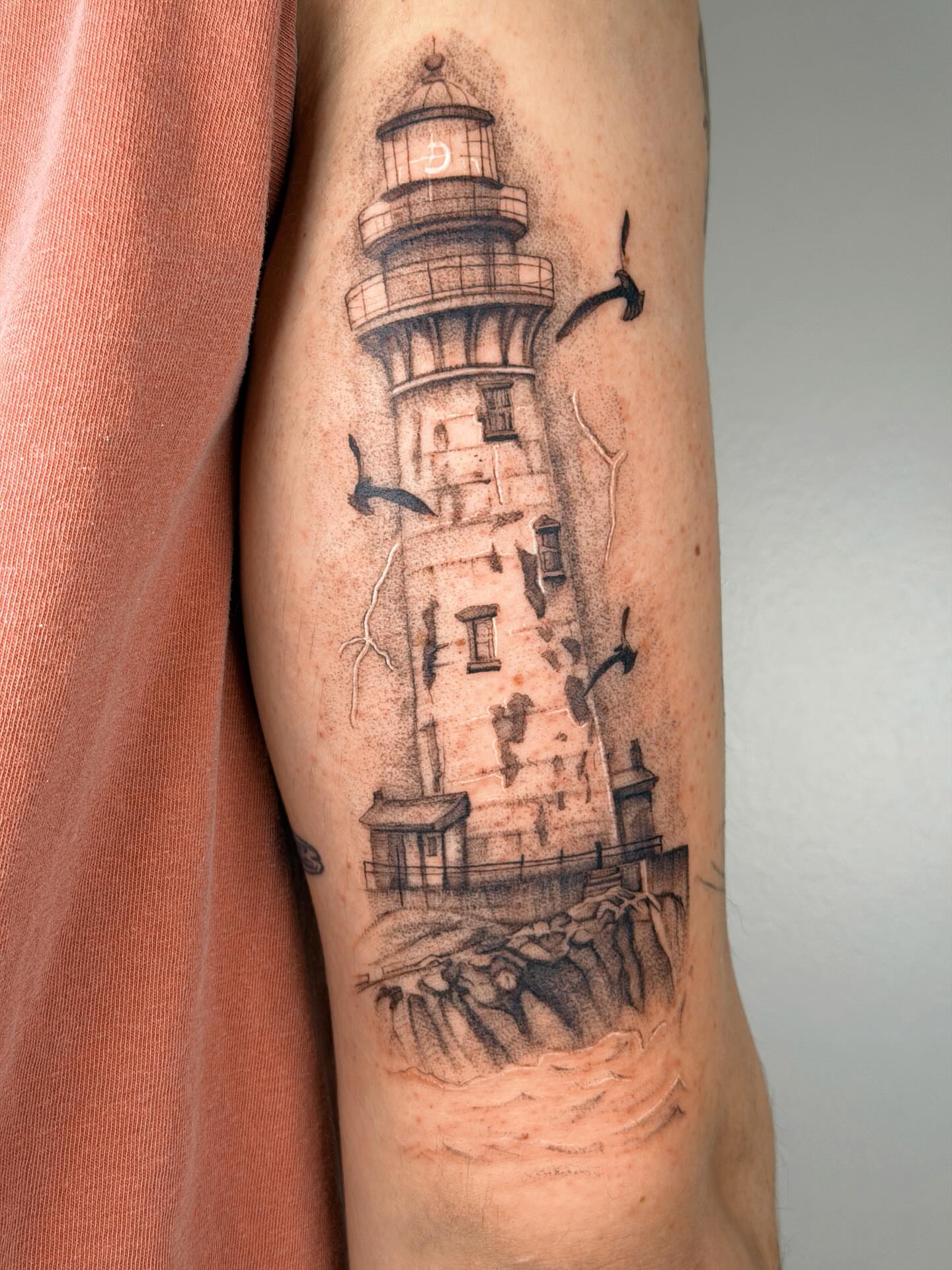 Lighthouse realism tattoo on the forearm by Nate Weaver