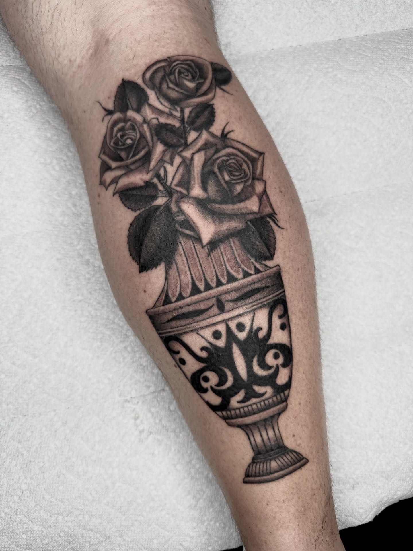 Roses in vase realism tattoo on the forearm by Joe Weber, Monona, Wisconsin