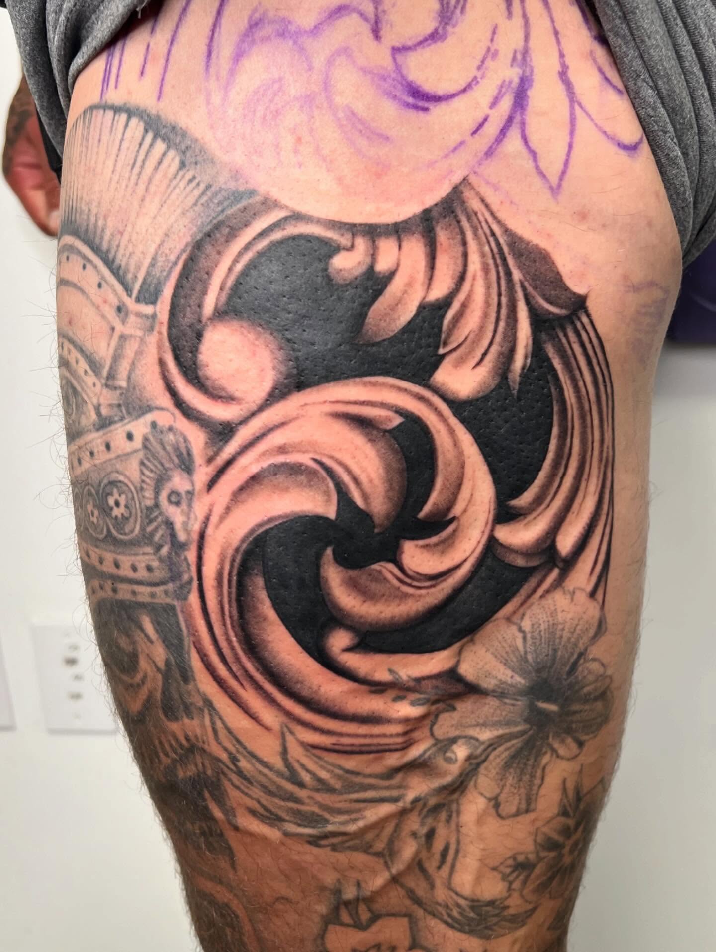 Swirl and floral realism tattoo on the thigh by San Diego Fineline Black & Grey Tattoo Artist