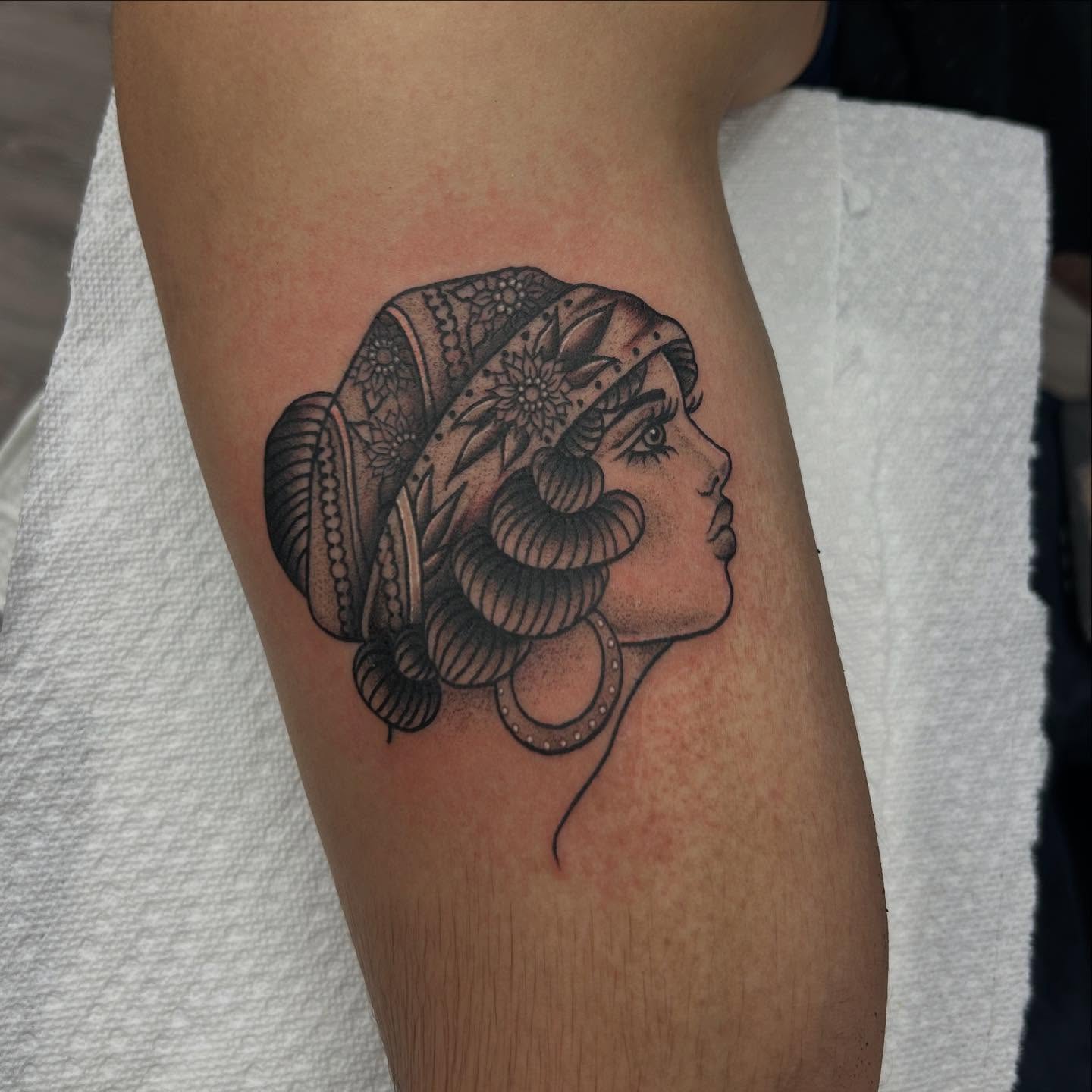 Woman with ornate headdress dotwork tattoo on the forearm by Livy baby
