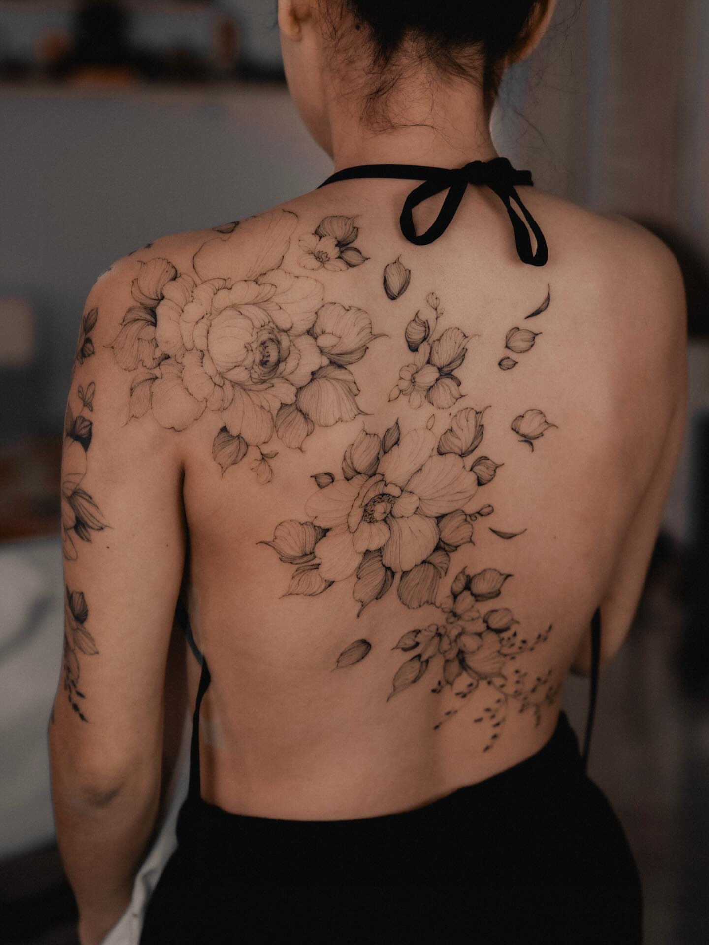 Floral bouquet realism tattoo on the back by Marek