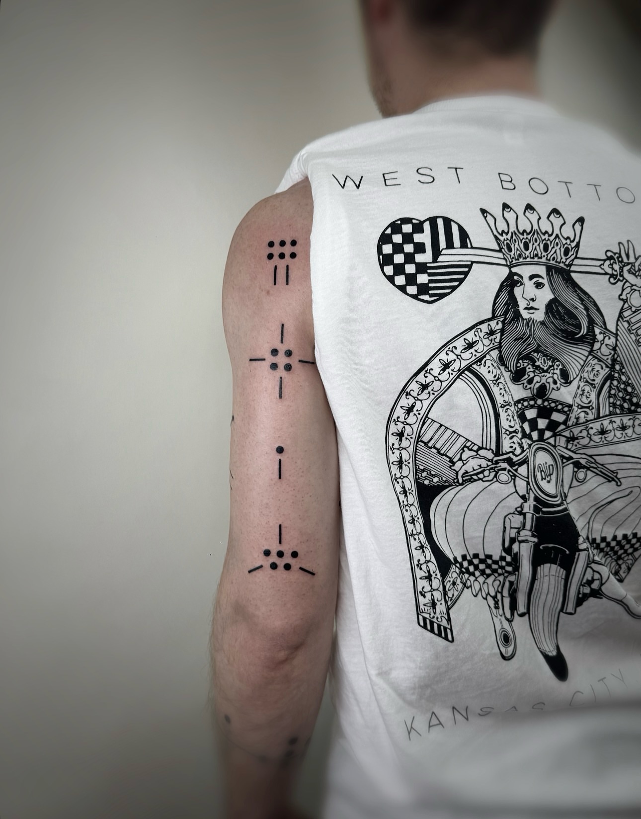 Queen on motorcycle dotwork tattoo on the upper arm by Jadyn Pang