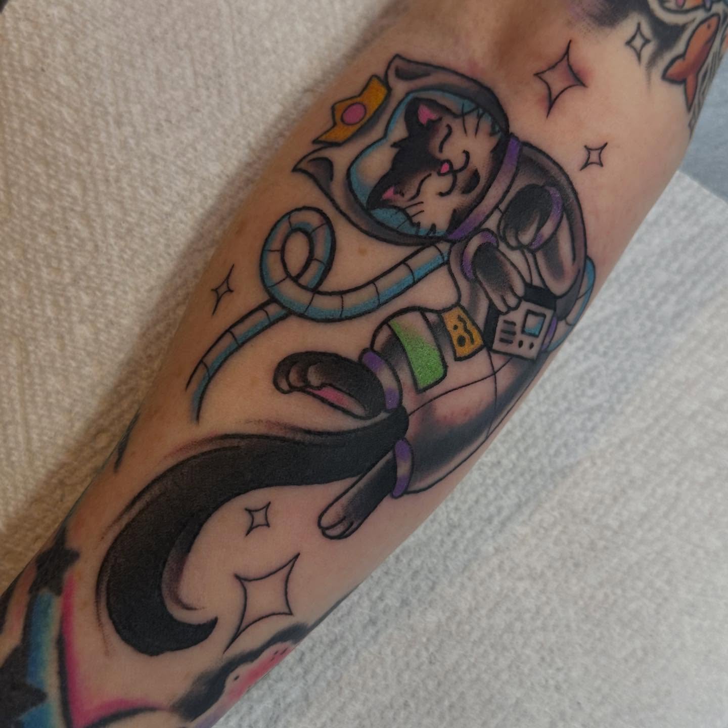 Cat astronaut American traditional tattoo on the forearm by Alexa Wolfkiel