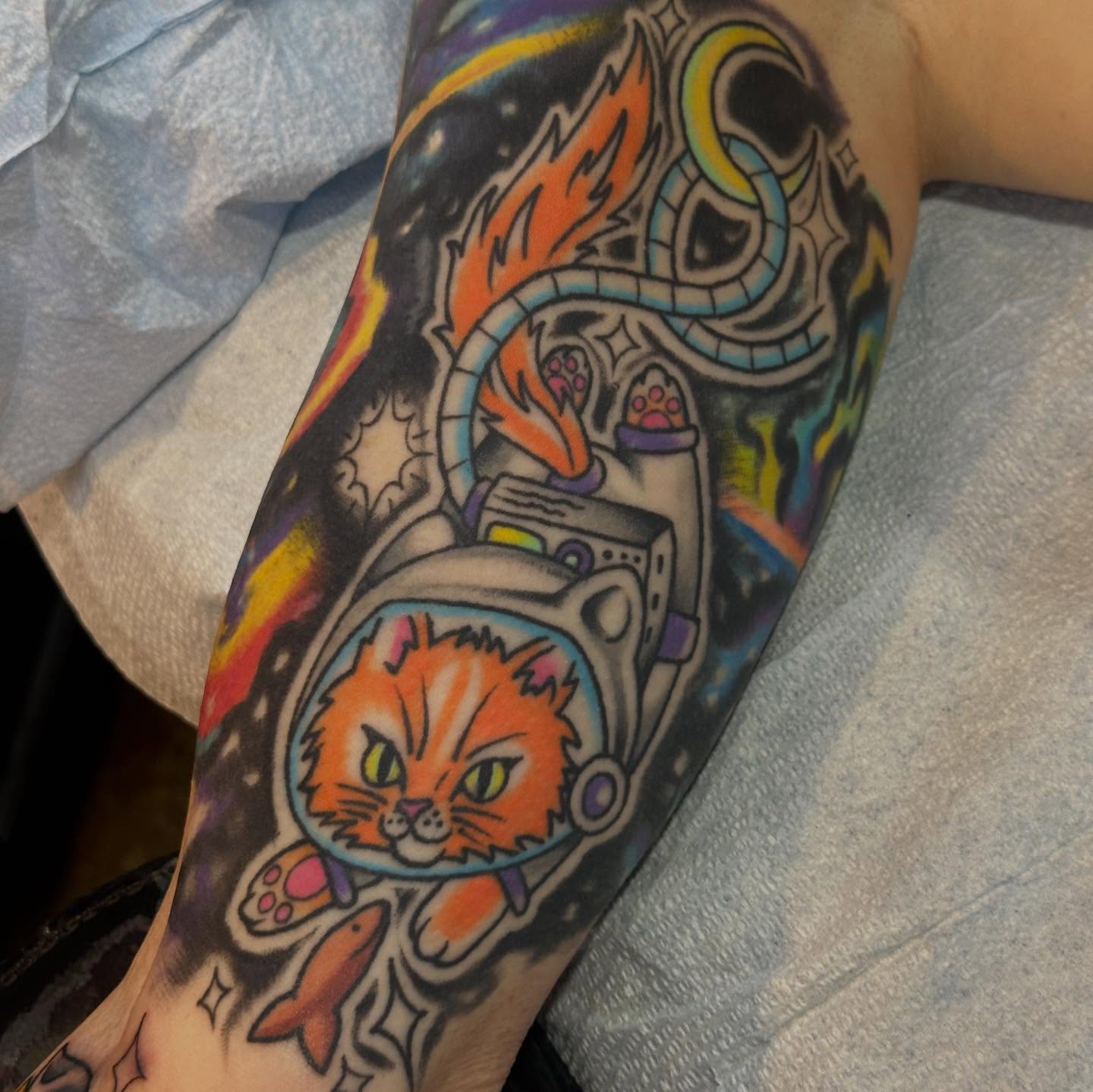Cat astronaut new school tattoo on the forearm by Alexa Wolfkiel