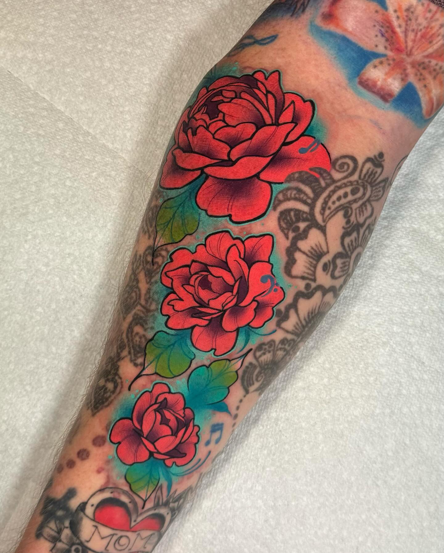 Roses American traditional tattoo on the forearm by Taylor Nicoll Chunn
