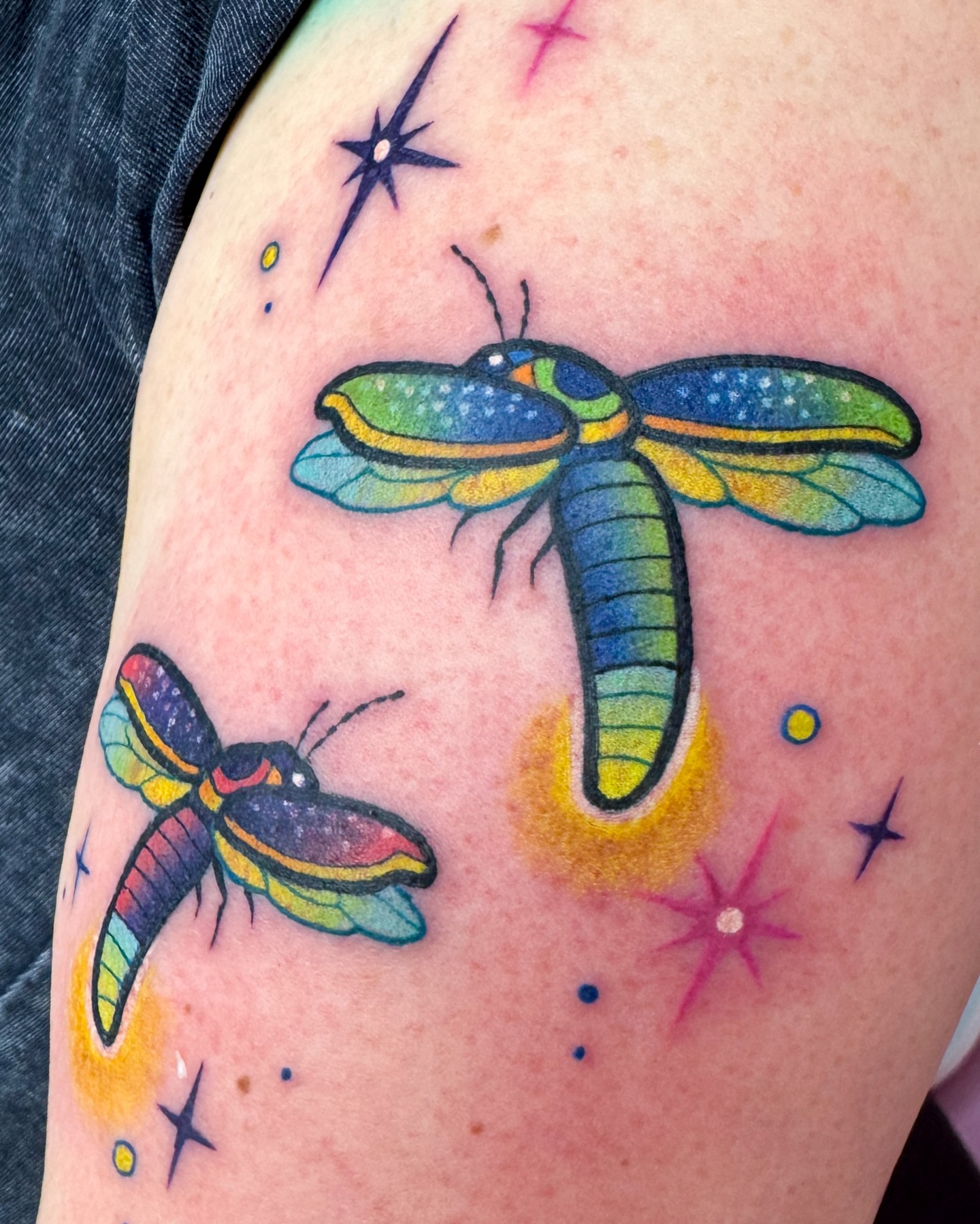 Moths new school tattoo on the upper arm by Janine Ramos