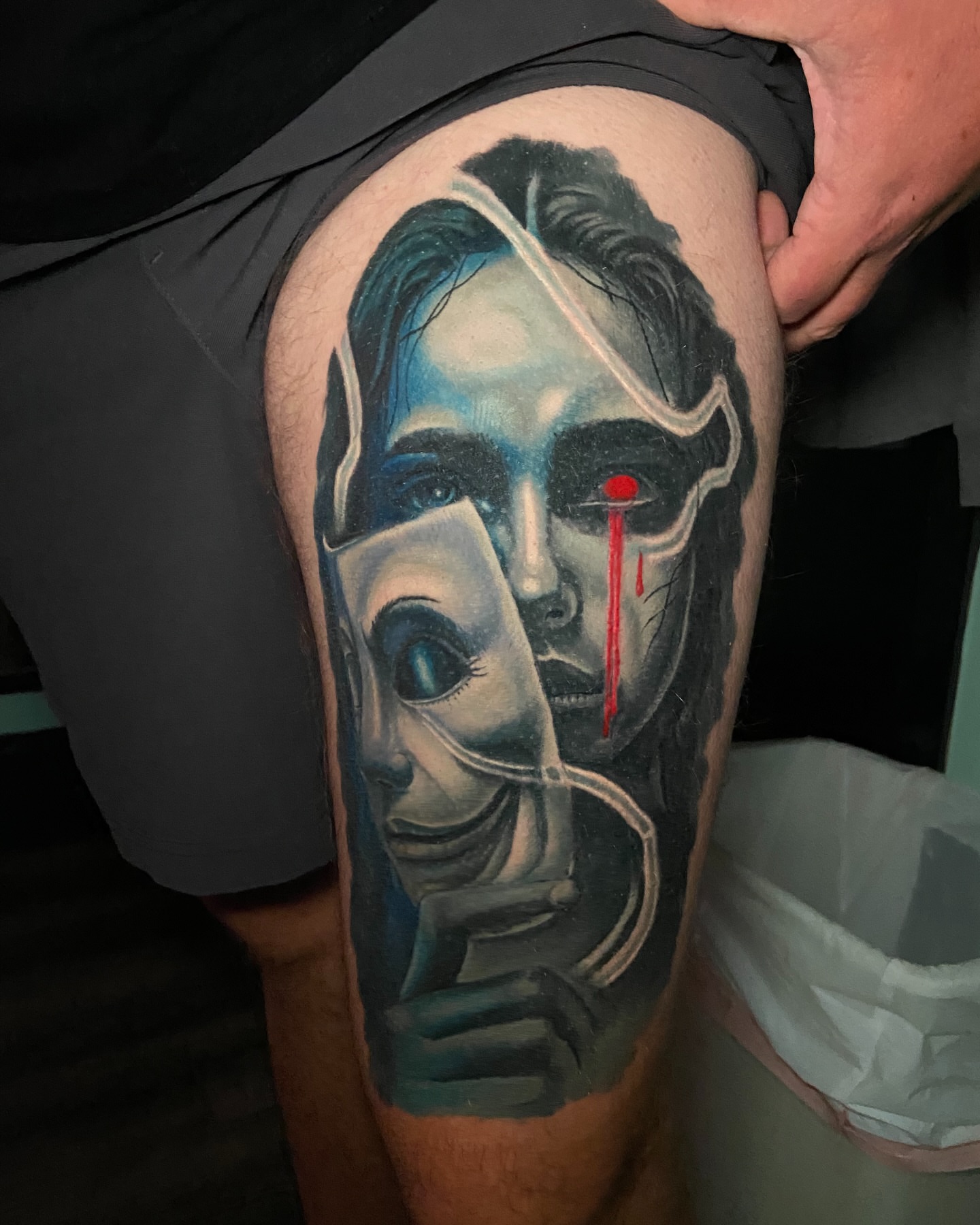 Abstract face realism tattoo on the thigh by Brandon Bowie