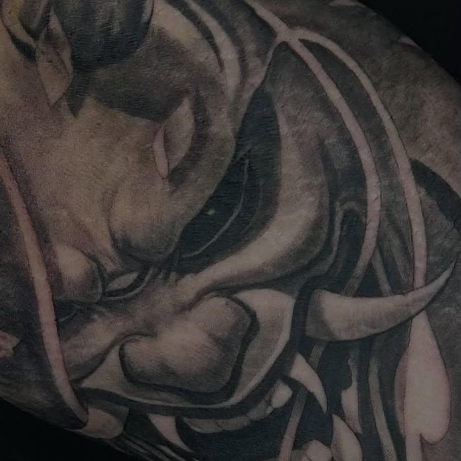 Demon face dark realism tattoo on the forearm by Matthew Doherty