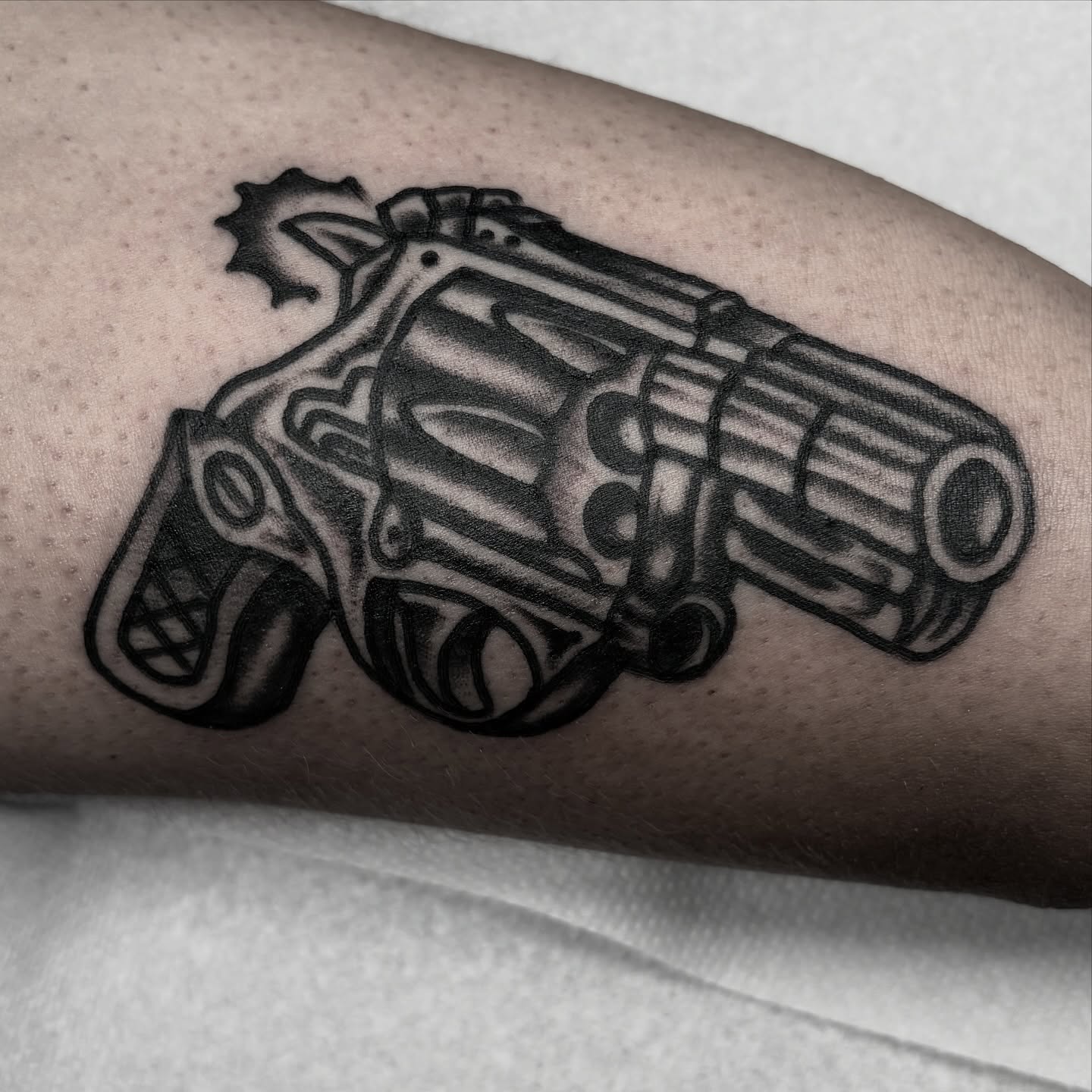 Revolver black and grey tattoo on the forearm by π³πππ πΆπππππ