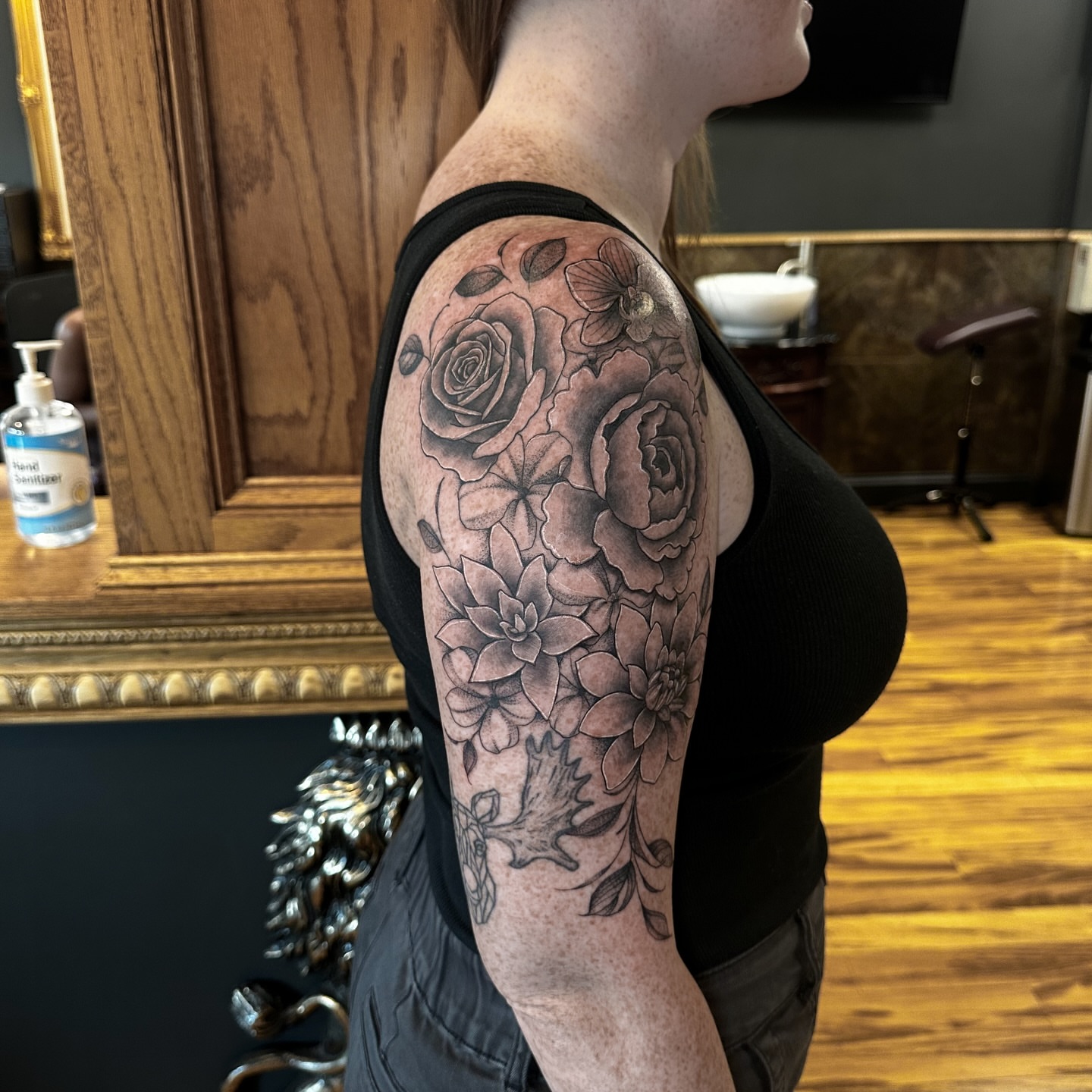 Floral bouquet black and grey tattoo on the upper arm by Leo Fernandes, Danvers, Massachusetts