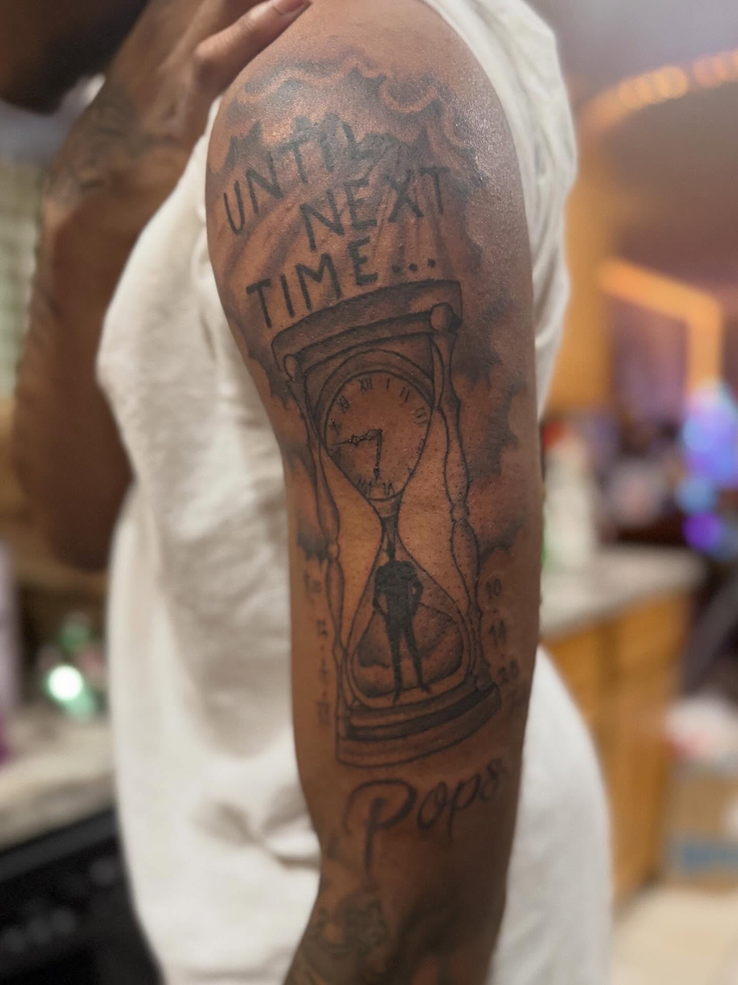Hourglass black and grey tattoo on the forearm by Aja Marie