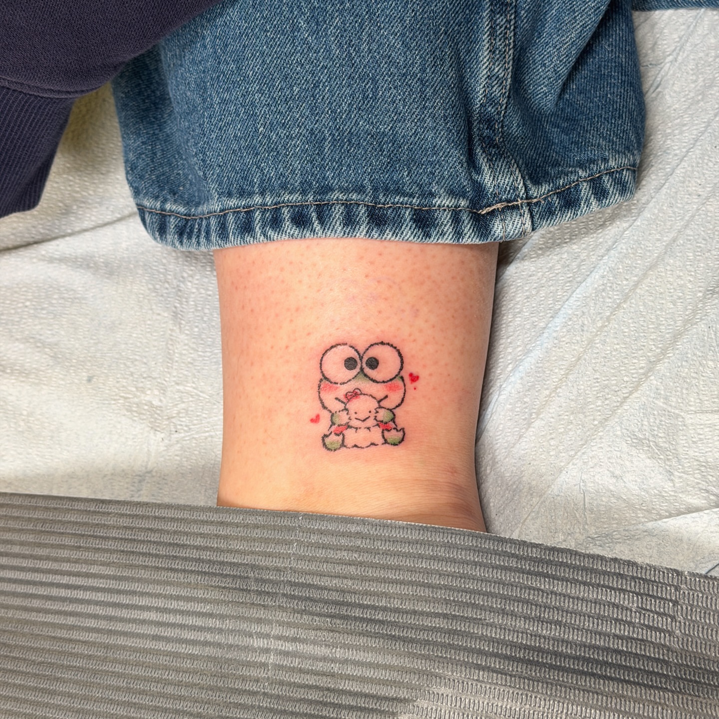 Frog holding a heart dotwork tattoo on the forearm by justin
