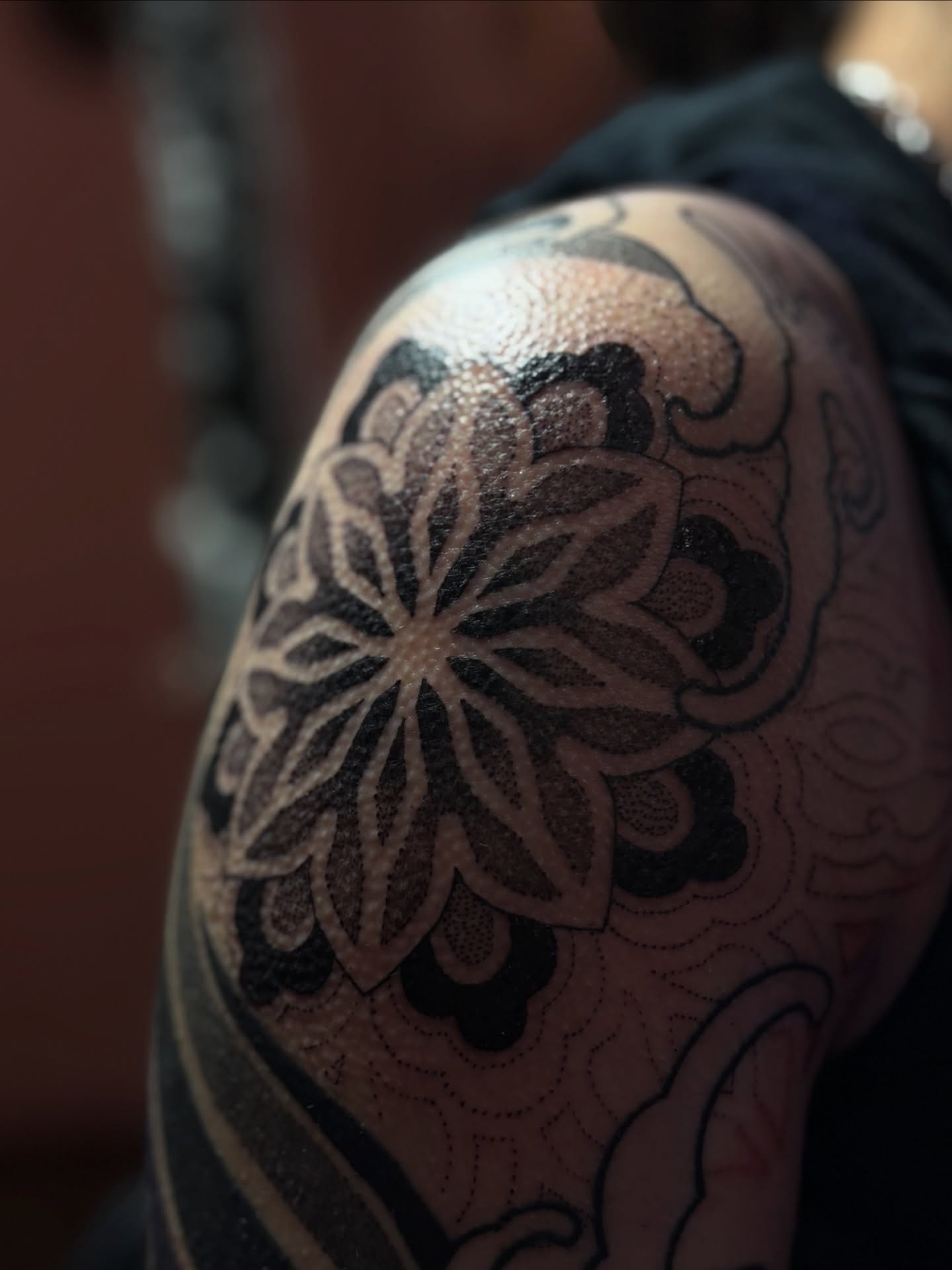 Floral pattern black and grey tattoo on the shoulder by Storm Smith