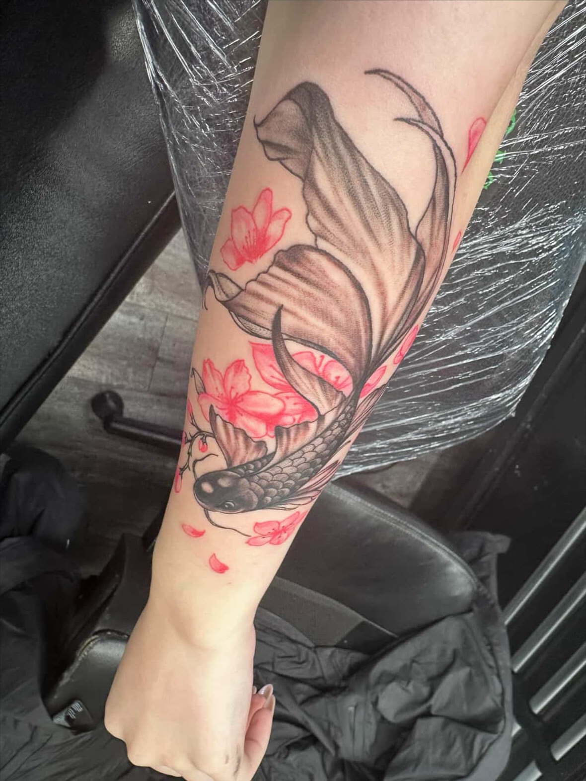 Koi fish and cherry blossoms japanese irezumi tattoo on the forearm by Shaunboweink