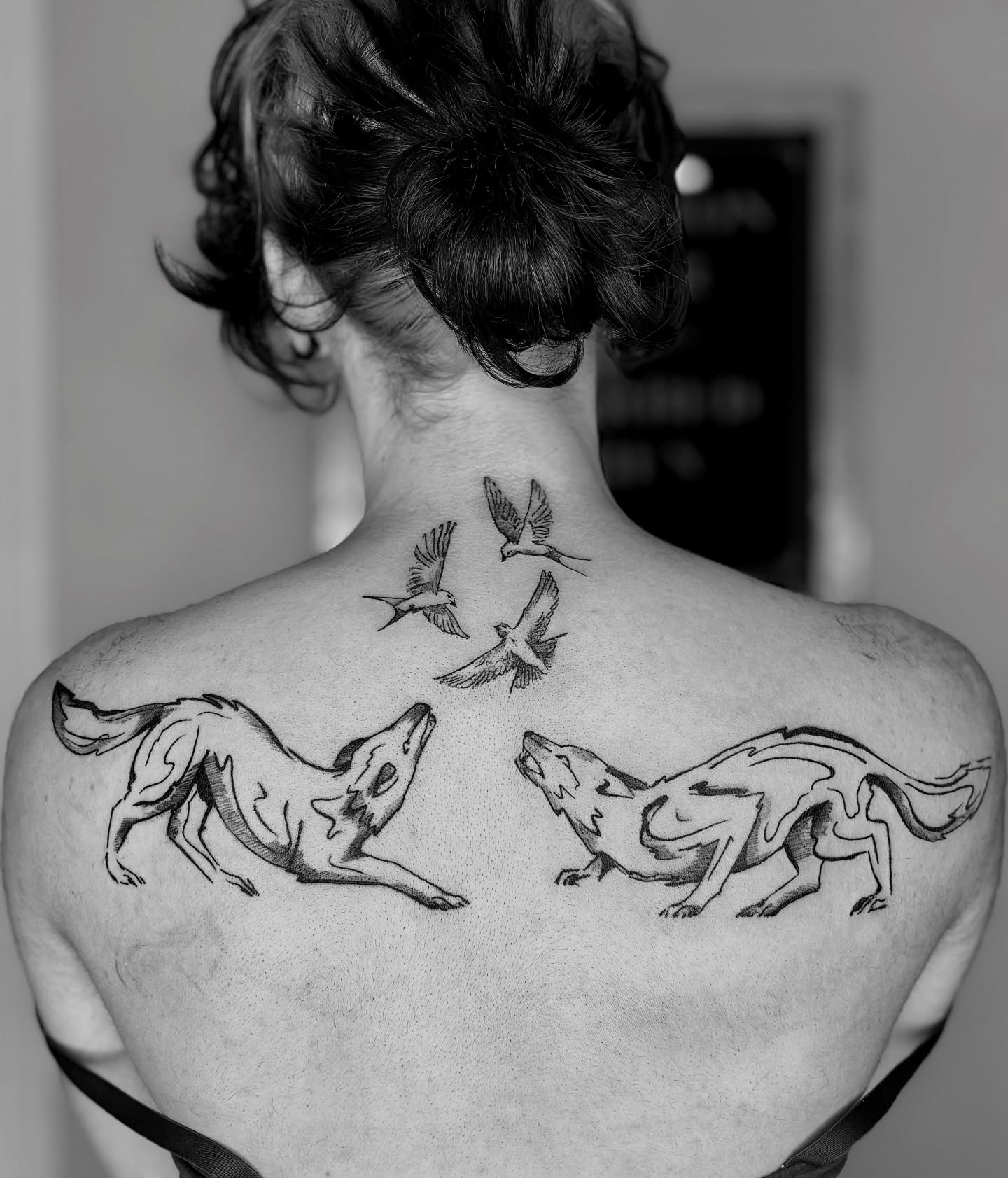 Wolves and birds black and grey tattoo on the back by Sarah