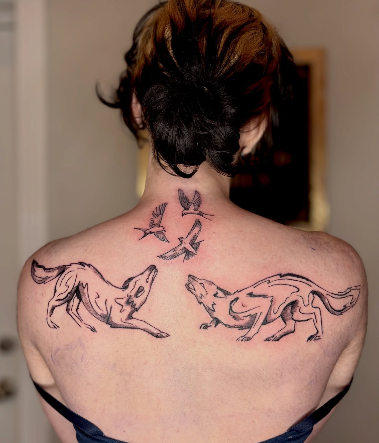 Wolves and birds black and grey tattoo on the back by Sarah