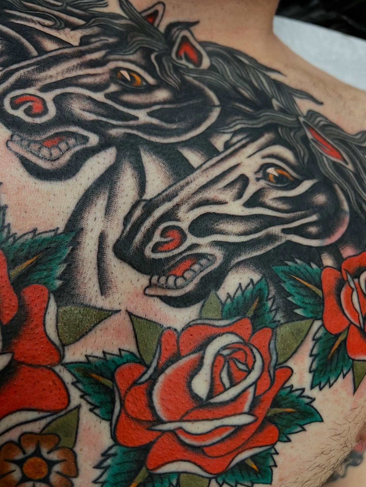 Horses and roses American traditional tattoo on the torso by Kelsey Lane