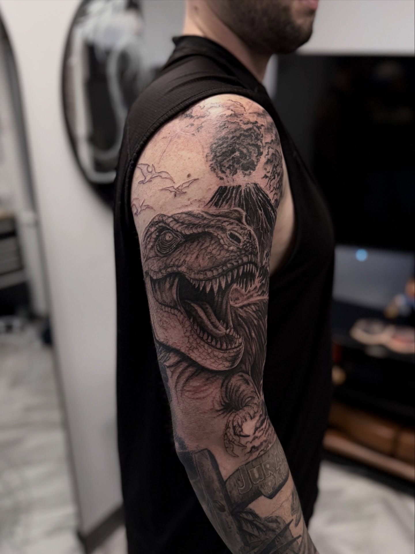Dinosaur realism tattoo on the upper arm by Sebastian