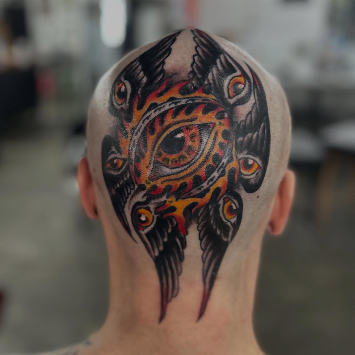 Eye with flames neo-traditional tattoo on the head by Dylan O'Quin