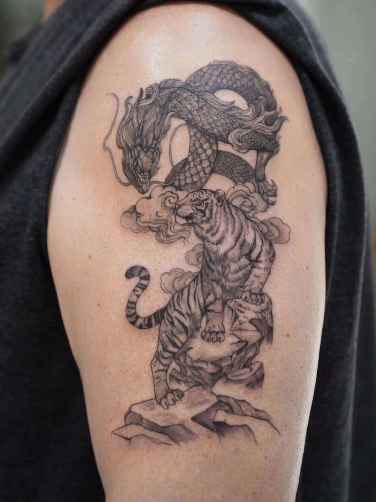 Dragon and tiger realism tattoo on the shoulder by MJ tattooist