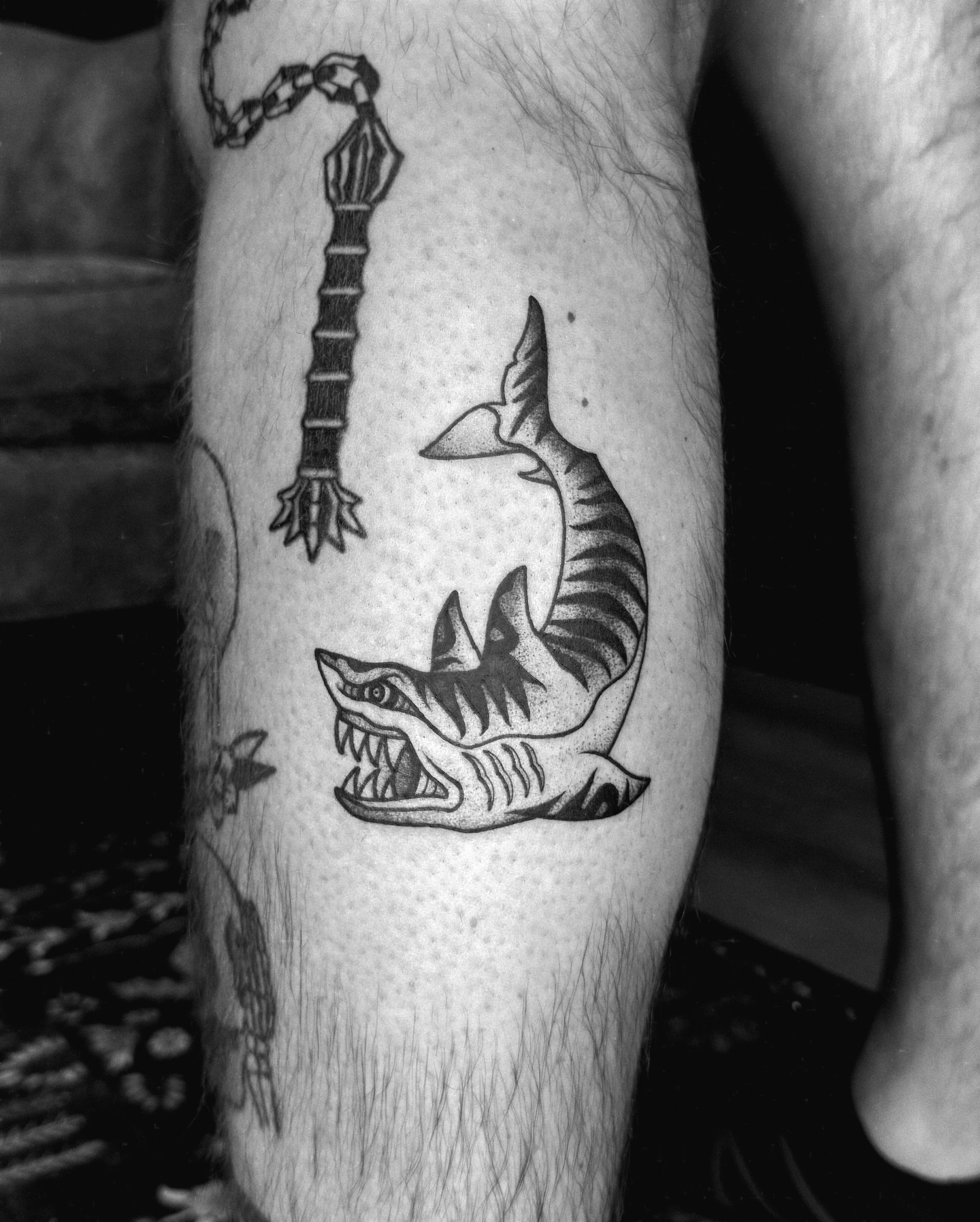 Shark biting hook dotwork tattoo on the forearm by 𝔍𝔞𝔯𝔢𝔡 𝔞𝔩𝔩𝔢𝔫