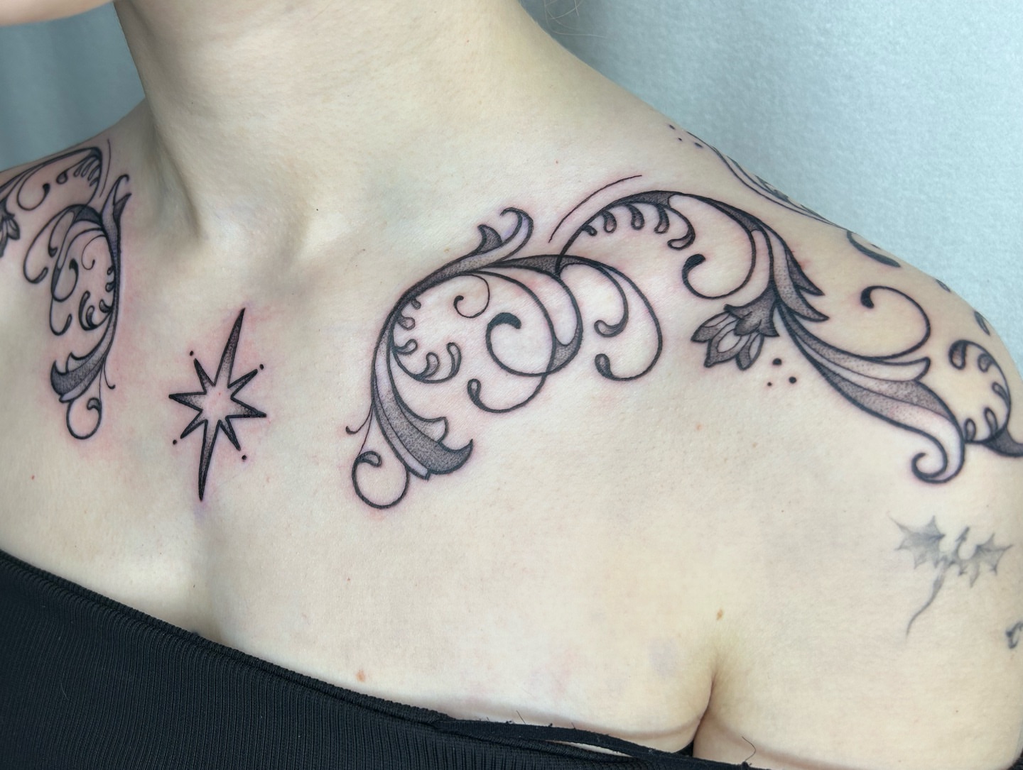 Scrollwork and star ornamental tattoo on the chest by Aaron Murray ✨ Michigan Tattoo Artist