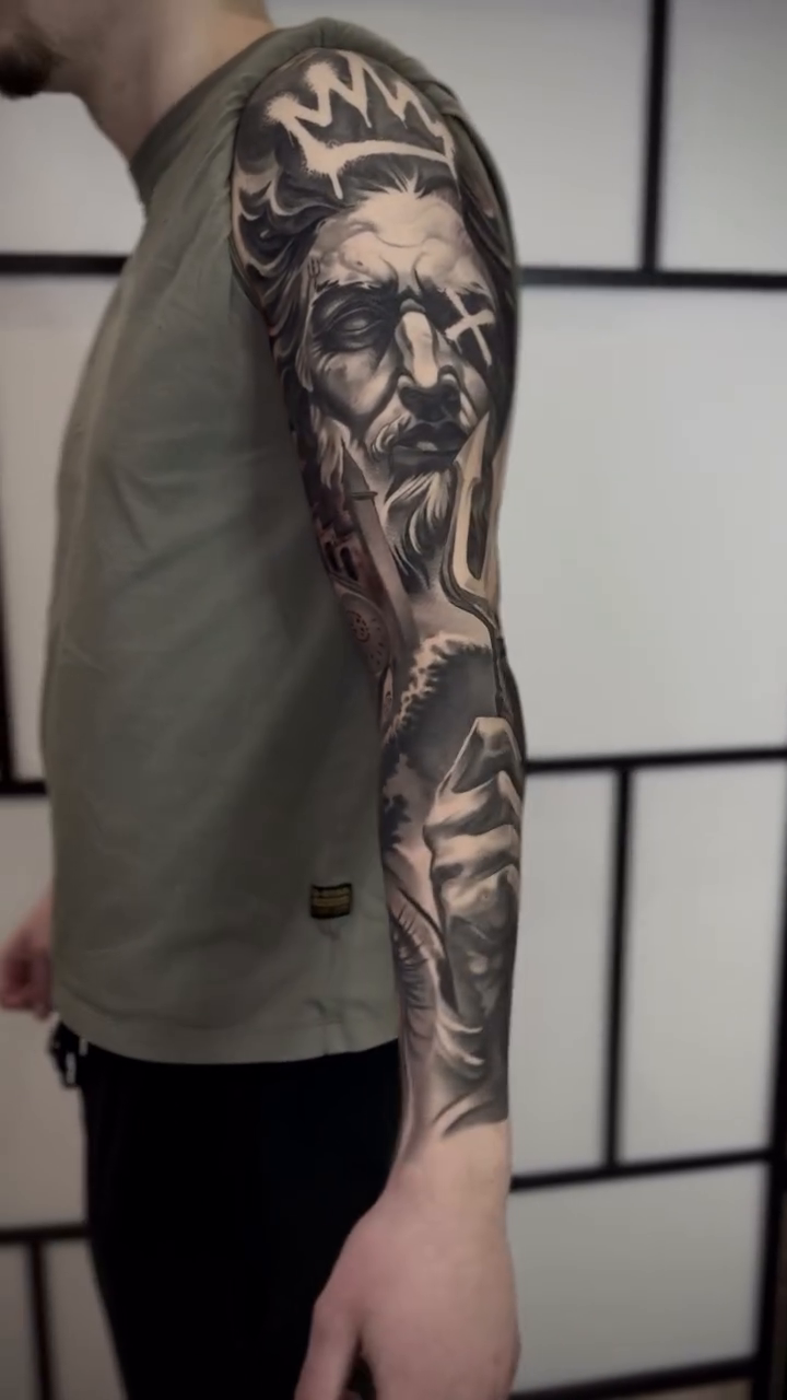 Man with trident realism tattoo by Tony Ink