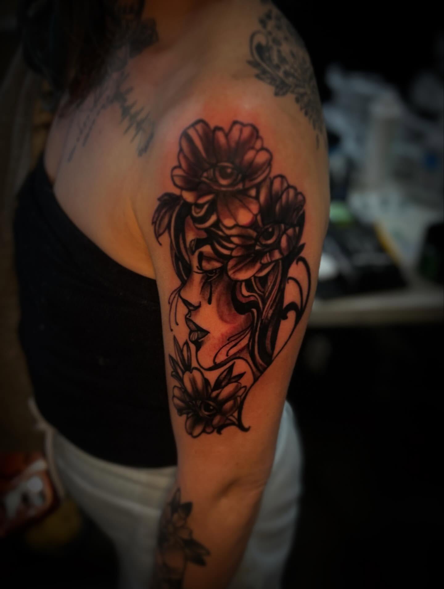 Woman with flowers black and grey tattoo on the shoulder by Rell Washington, Marlow Heights, Maryland