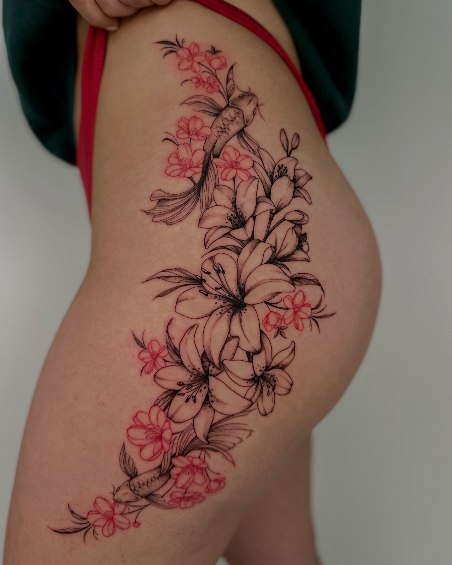 Cherry blossoms and koi fish japanese irezumi tattoo on the thigh by Lauren