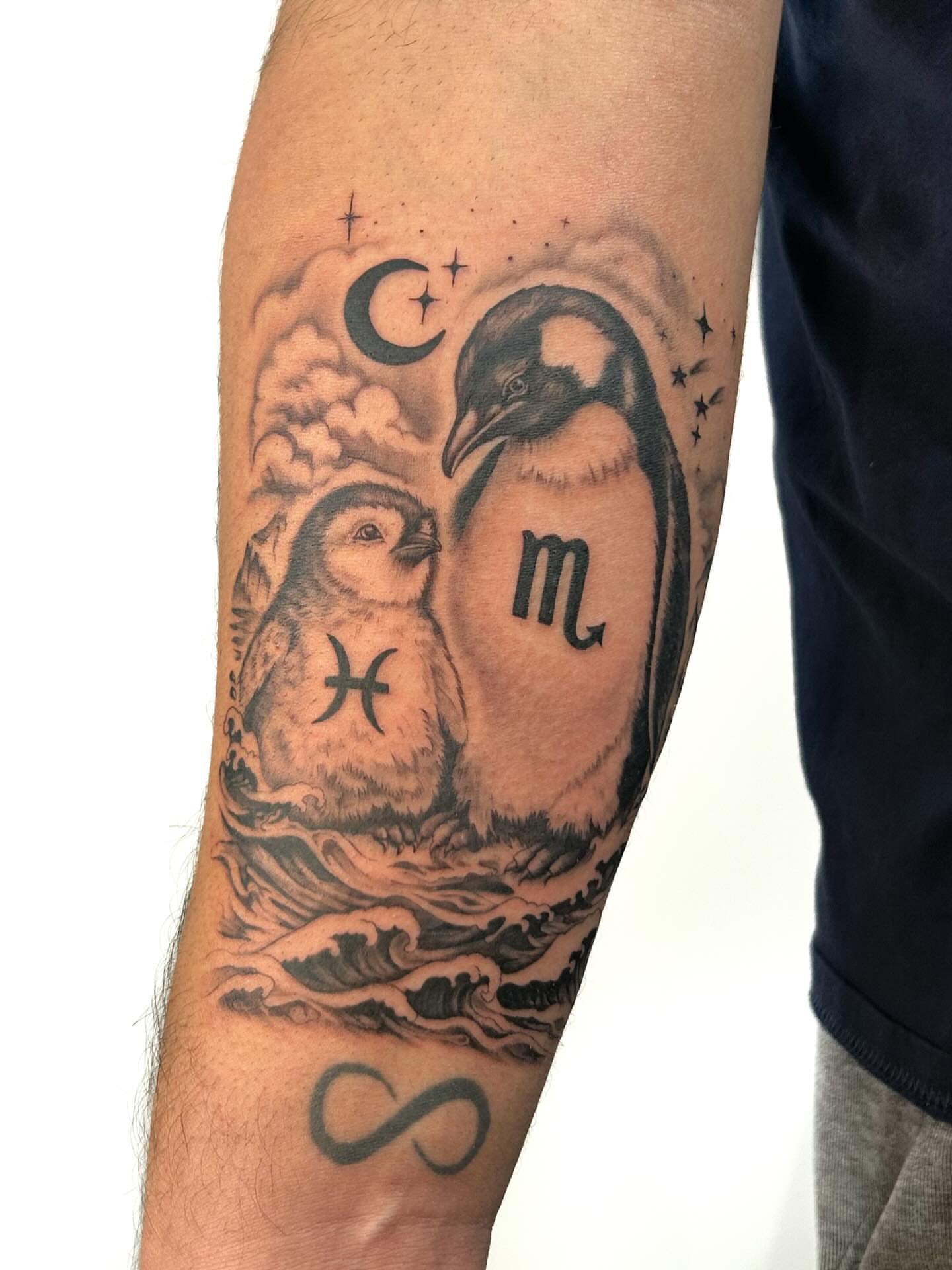 Penguins and zodiac symbols black and grey tattoo on the forearm by Chloe