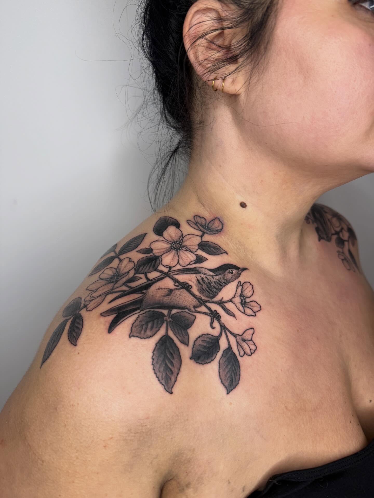 Bird and blossoms black and grey tattoo on the shoulder by Samantha Compasso Ford